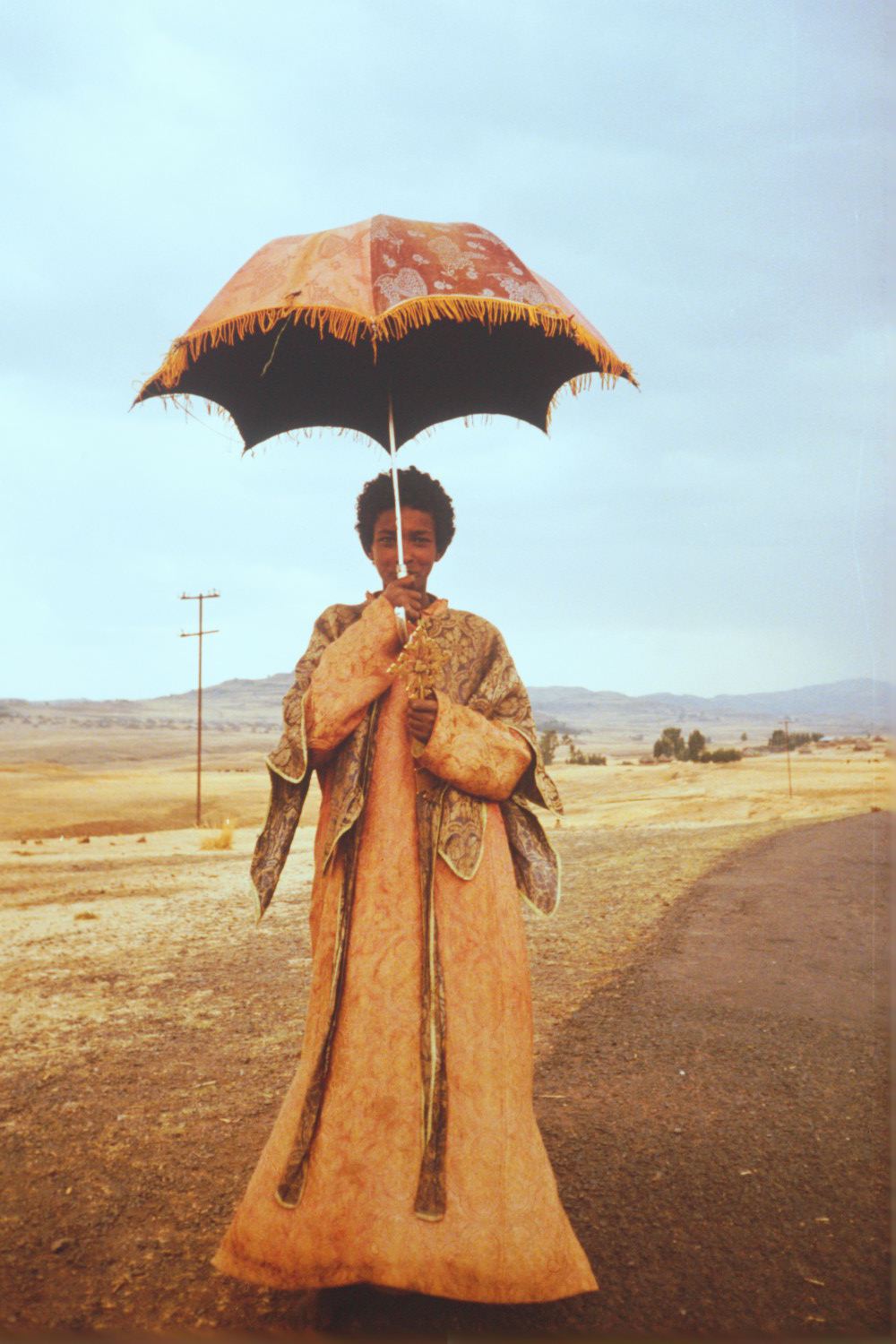 Young deacon with umbrella.jpg