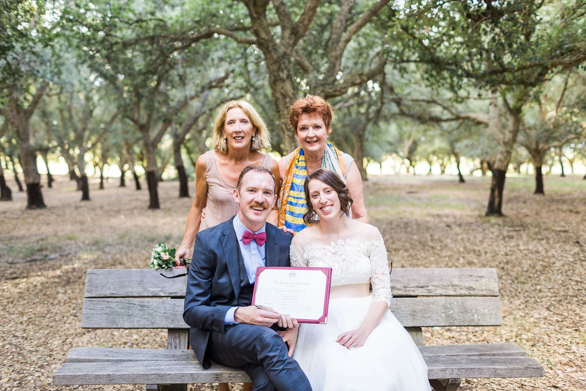 Bride and groom together with their mums after signing the marriage certificate