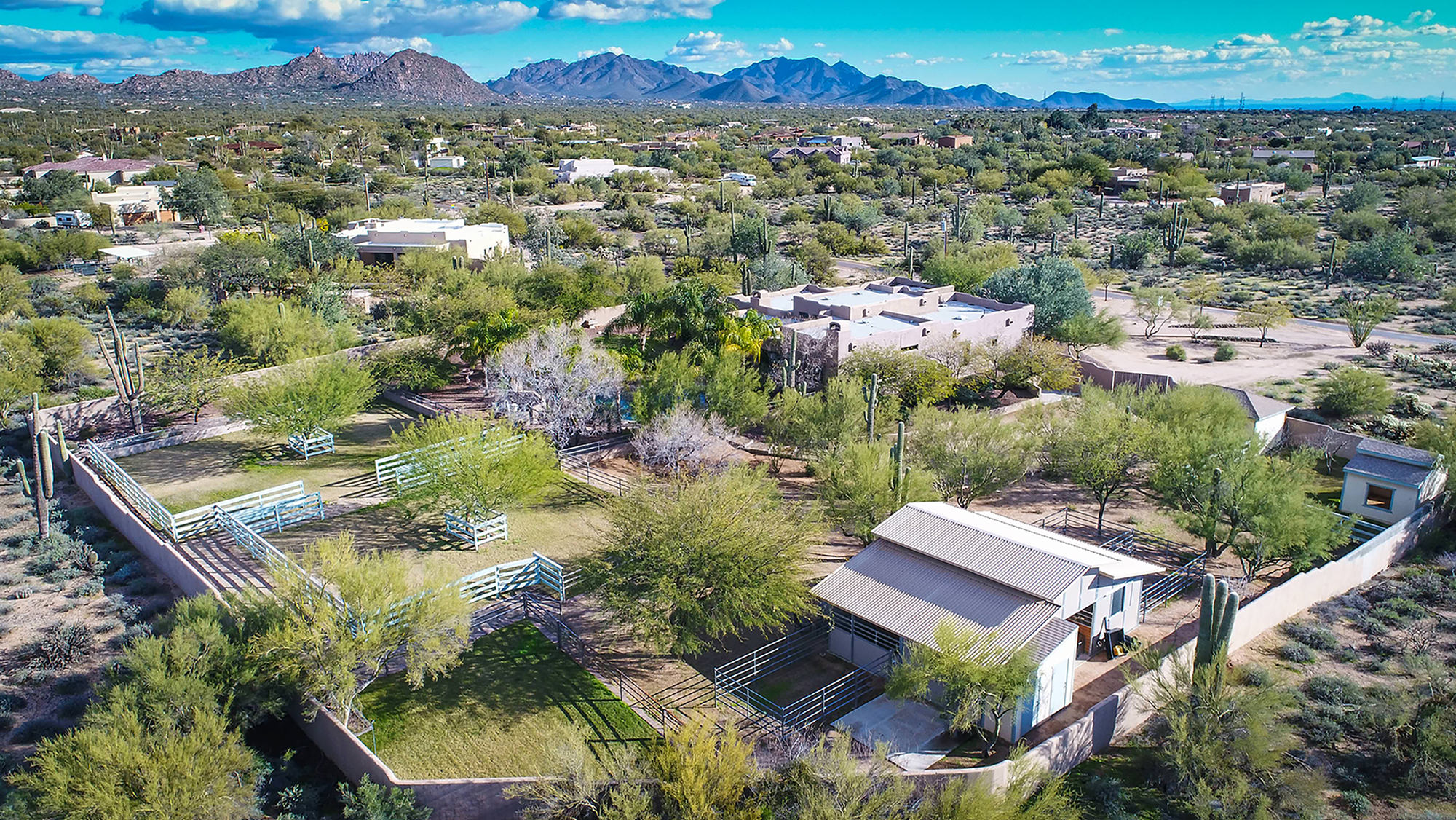 Overview of enclosed lush residential home and horse facility in North Scottsdale.
