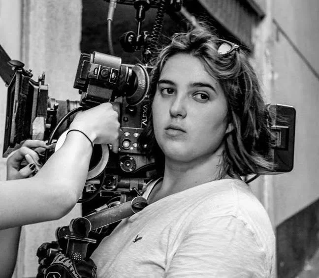 Natalia Bougadellis is a young Director and Cinematographer from Athens, Greece. She has studied Film and Television at New York University's Tisch School of the Arts. She is currently based in New York City, yet her directorial debut is “The Owls,” a short film shot in her hometown, Athens. Natalia is invested in queer film narratives and to the promotion of gender equality in film, and she has received several distinctions and awards for her work. She has served as one of the Co-directors of Fusion Film Festival, a festival that promotes women in film and is part of the Sundance Initiative for Women. Natalia has also worked on numerous short films as a Director of Photography in Dublin, Athens, Abu Dhabi, and New York www.nataliabougadellis.com . 