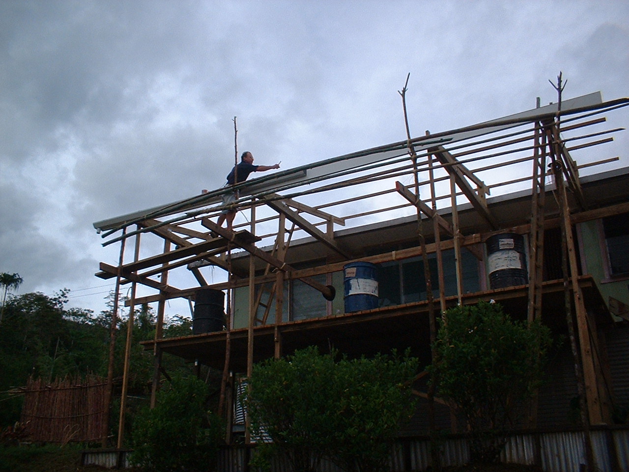 Ray laying roof on new porch.JPG