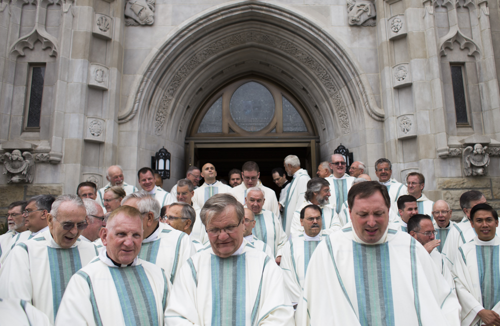 Priests exit the Blessed Sacrament Cathedral in Greensburg, Pa. after three deacons were ordained priests.