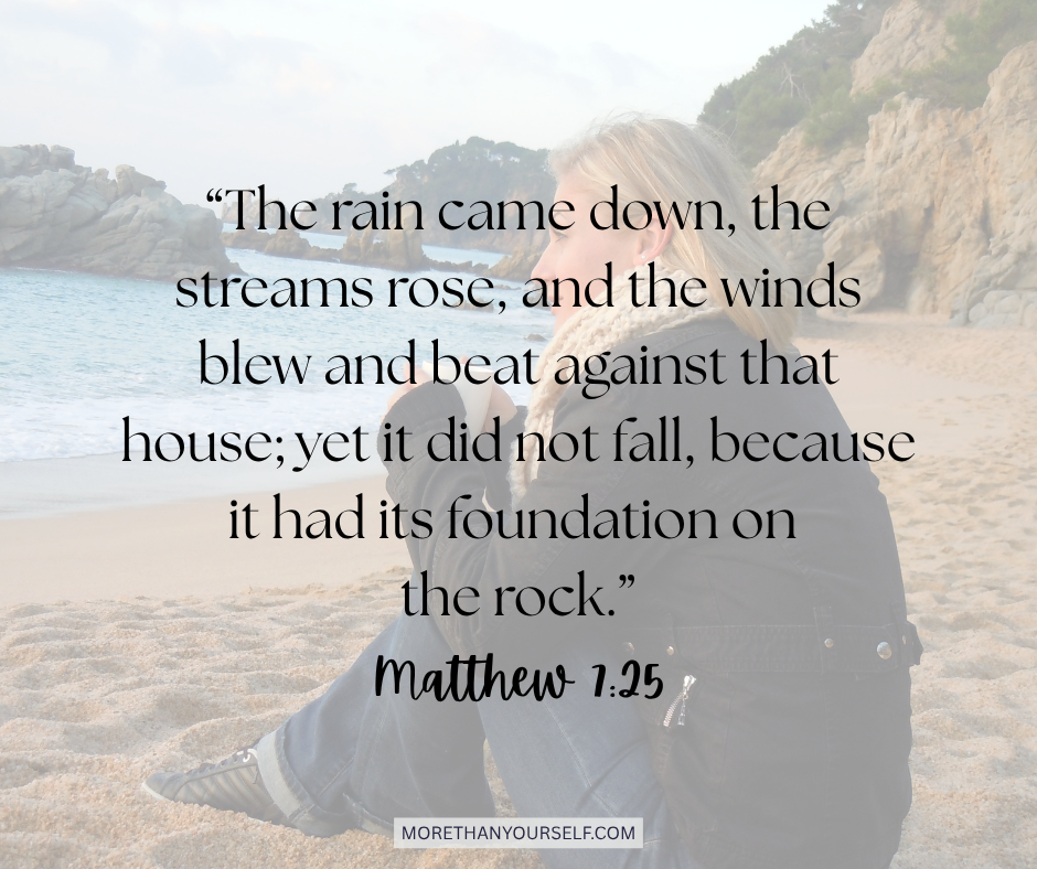 Woman sitting on a beach alone on a cold day. Text is Matthew 7:25.