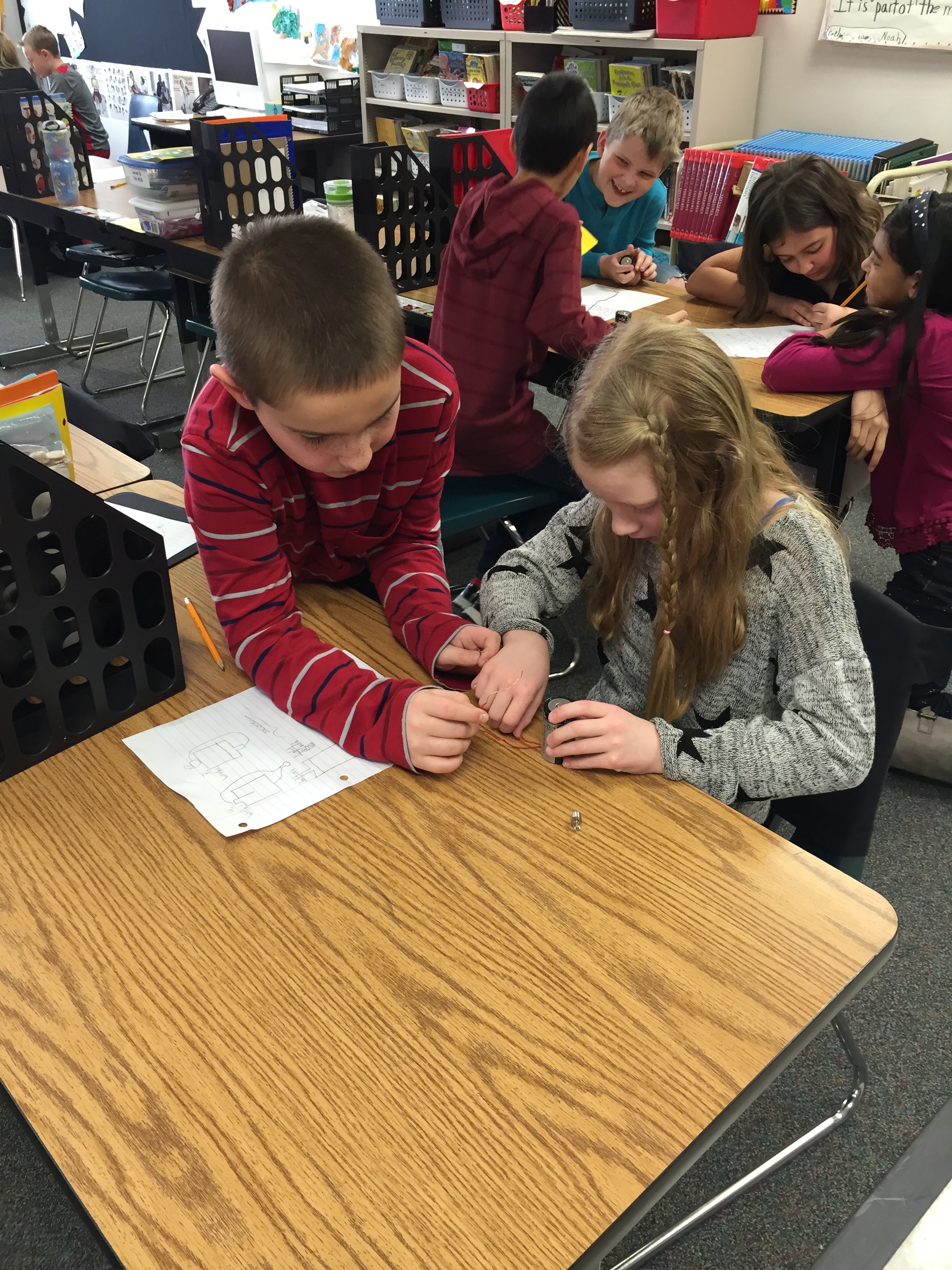 Students collaborate at an Inquiry Center - exploring the concept of Parts to Whole in science.