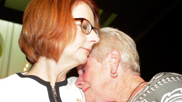 Julia Gillard is hugged after she offered the national apology for forced adoptions in the Great Hall at Parliament House on Thursday. Photo: Andrew Meares .