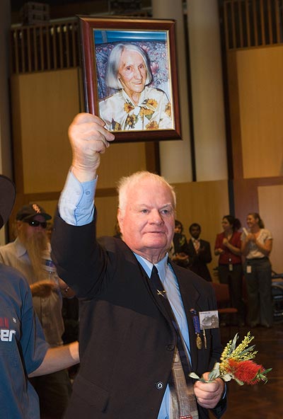 John Hennessey OAM, former child migrant, with photo of his late mother. Photo: George Serras, National Museum of Australia.