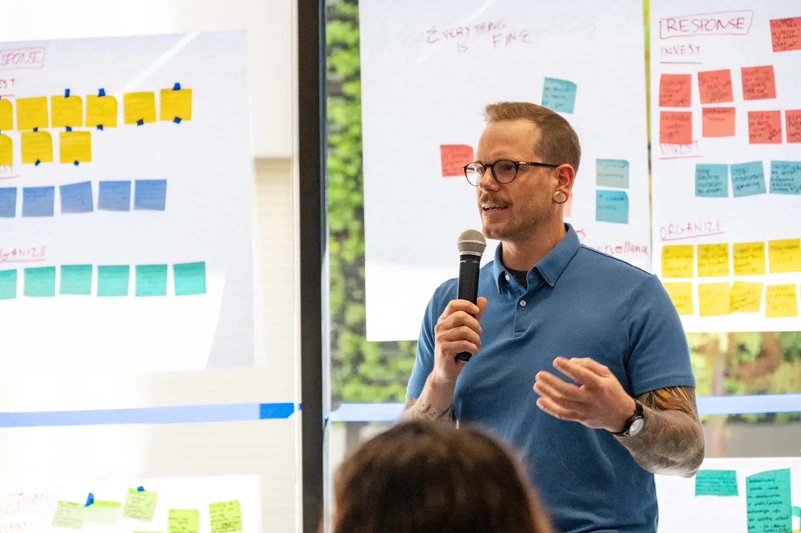 A The Ready consultant speaking to a group with a microphone during a workshop.