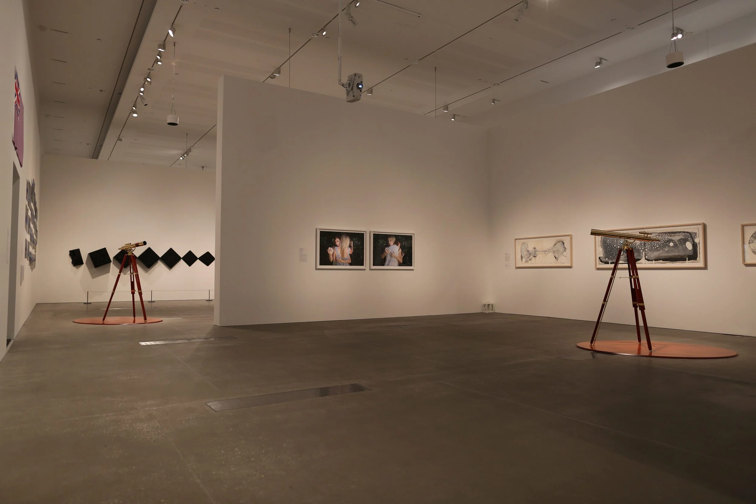 beyond the horizon (Installation View QOMA), 2015, Modified Brass Telescopes, Sound, and Digital Video.