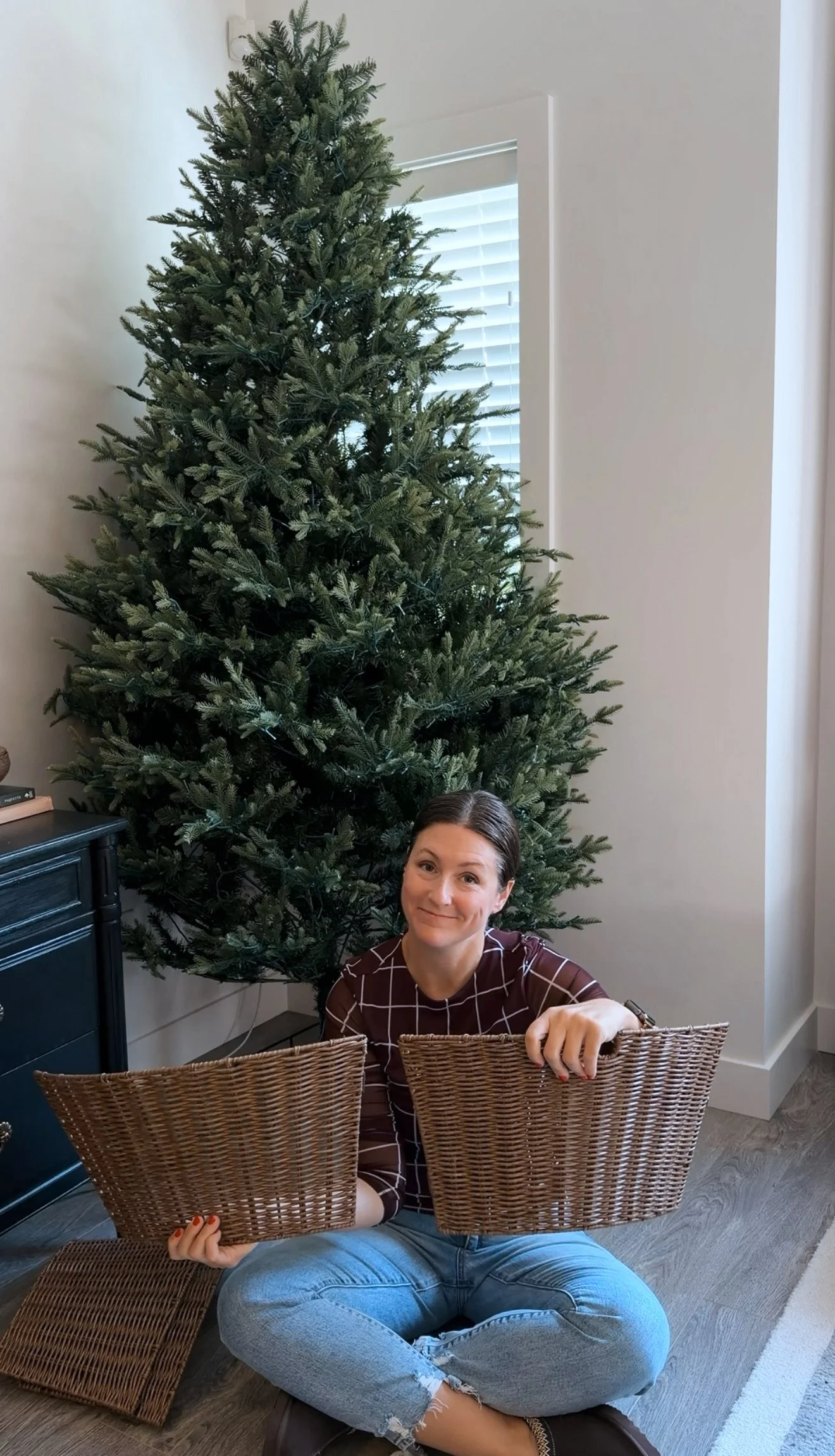 Affordable Christmas tree basket made from a $40 woven tree collar and cozy blankets