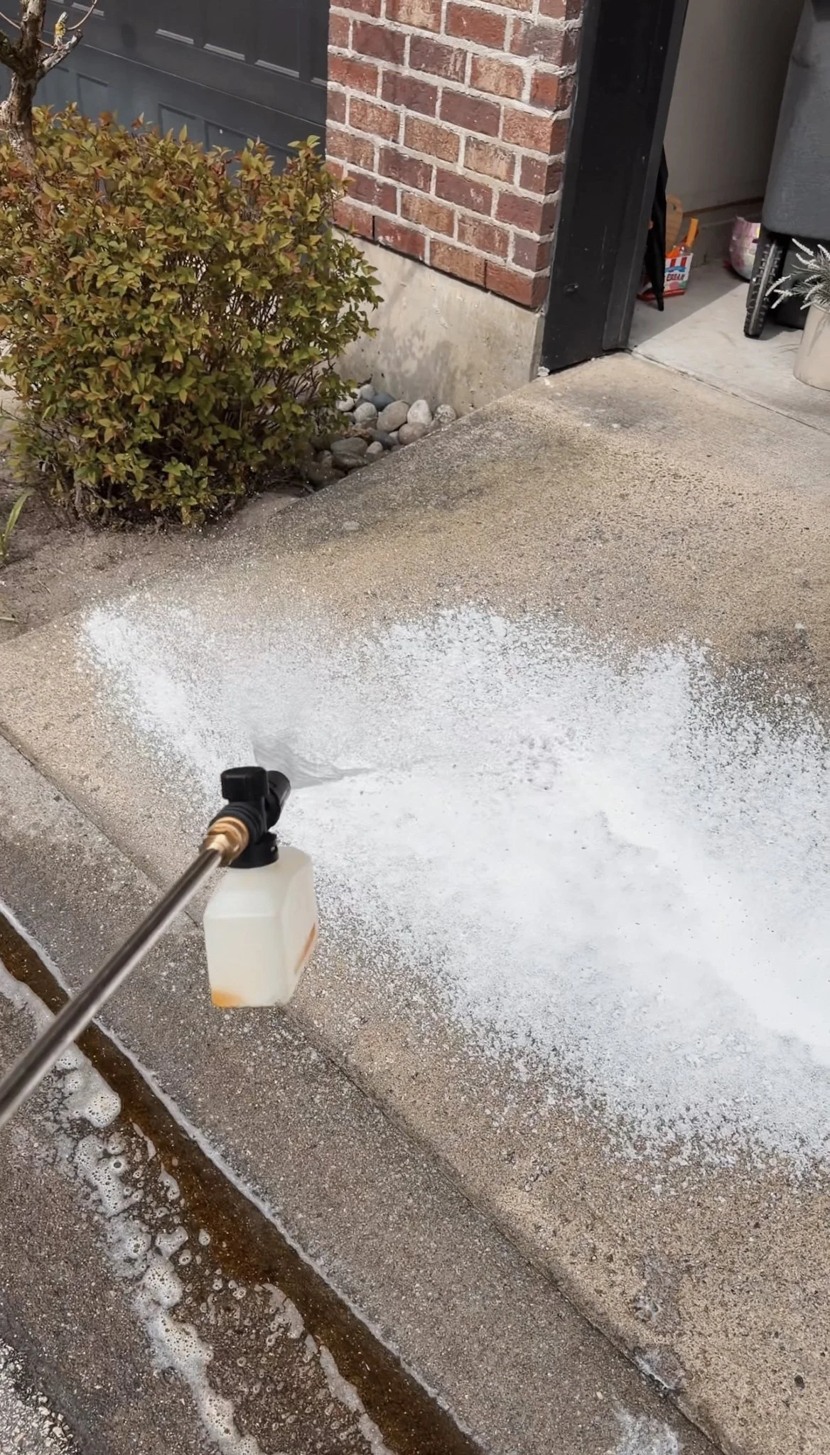 spring cleaning tips: pressure washing a driveway and patio
