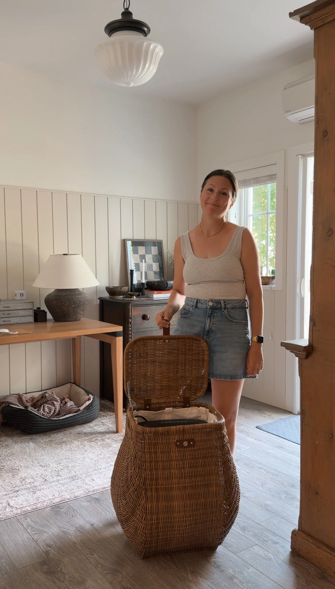 Decorative hamper used to hide a paper shredder in a home office