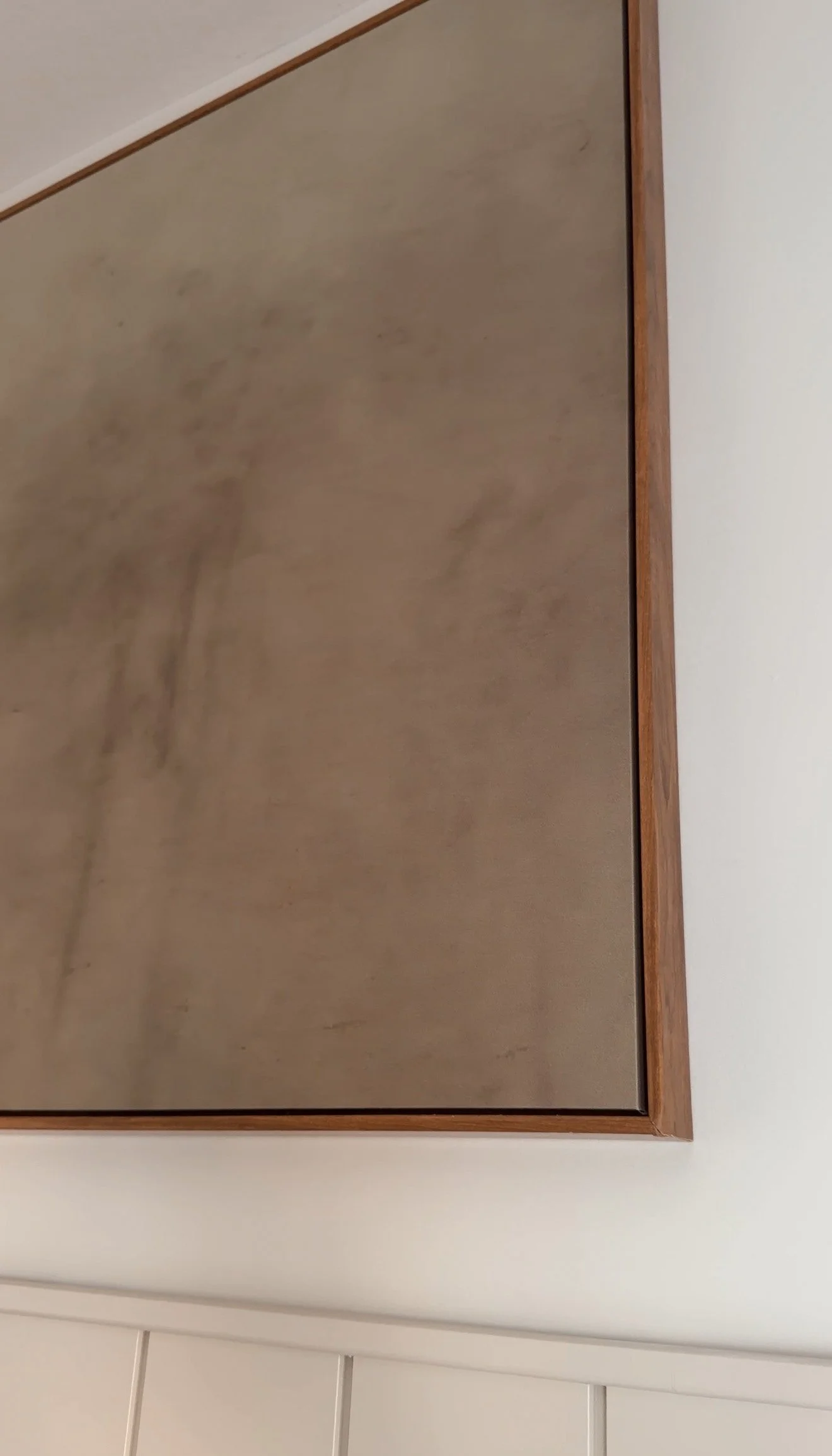 Large canvas wall art displayed above shiplap in a modern organic office