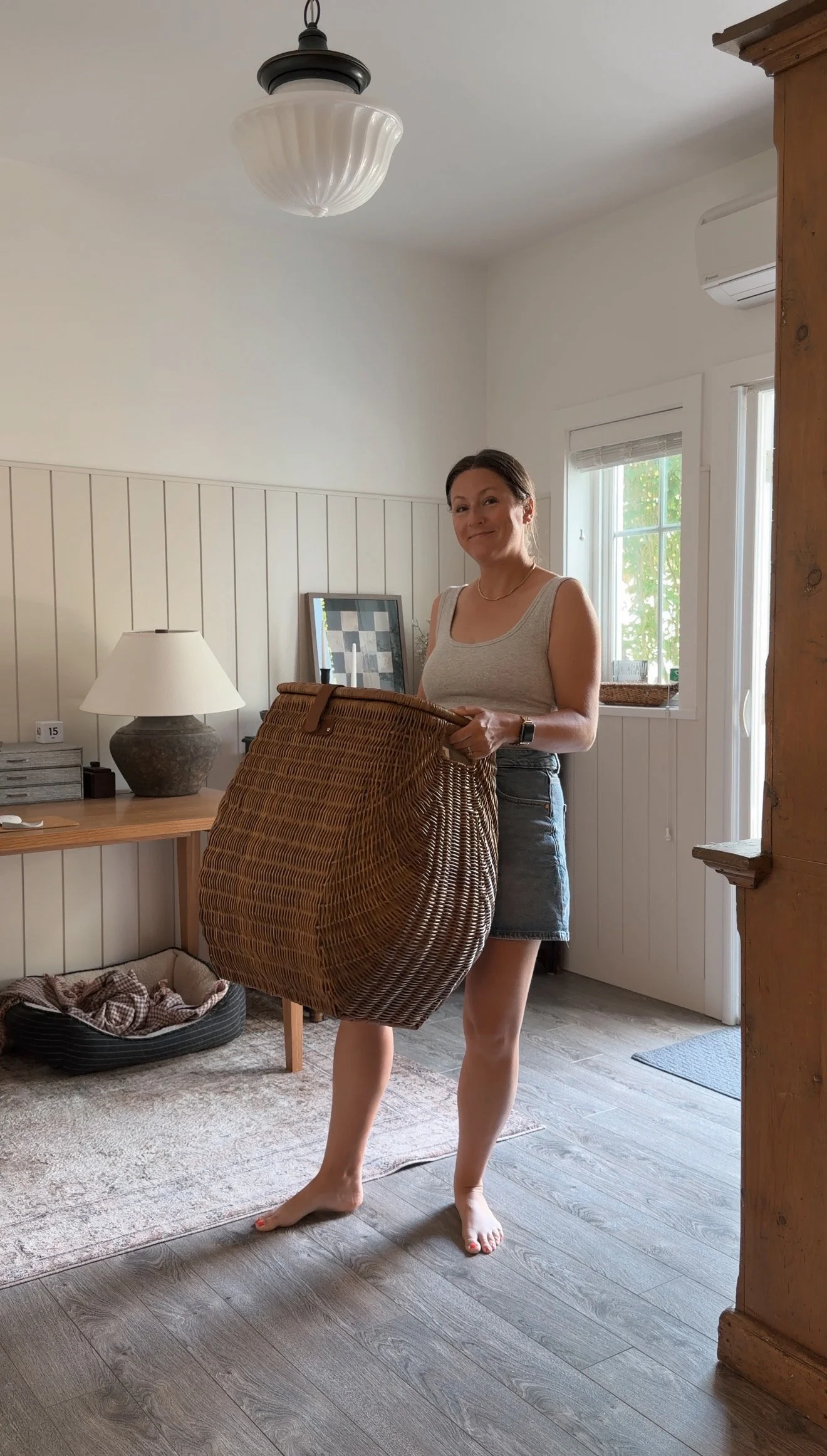 Paper shredder hidden inside a decorative hamper in an aesthetic home office