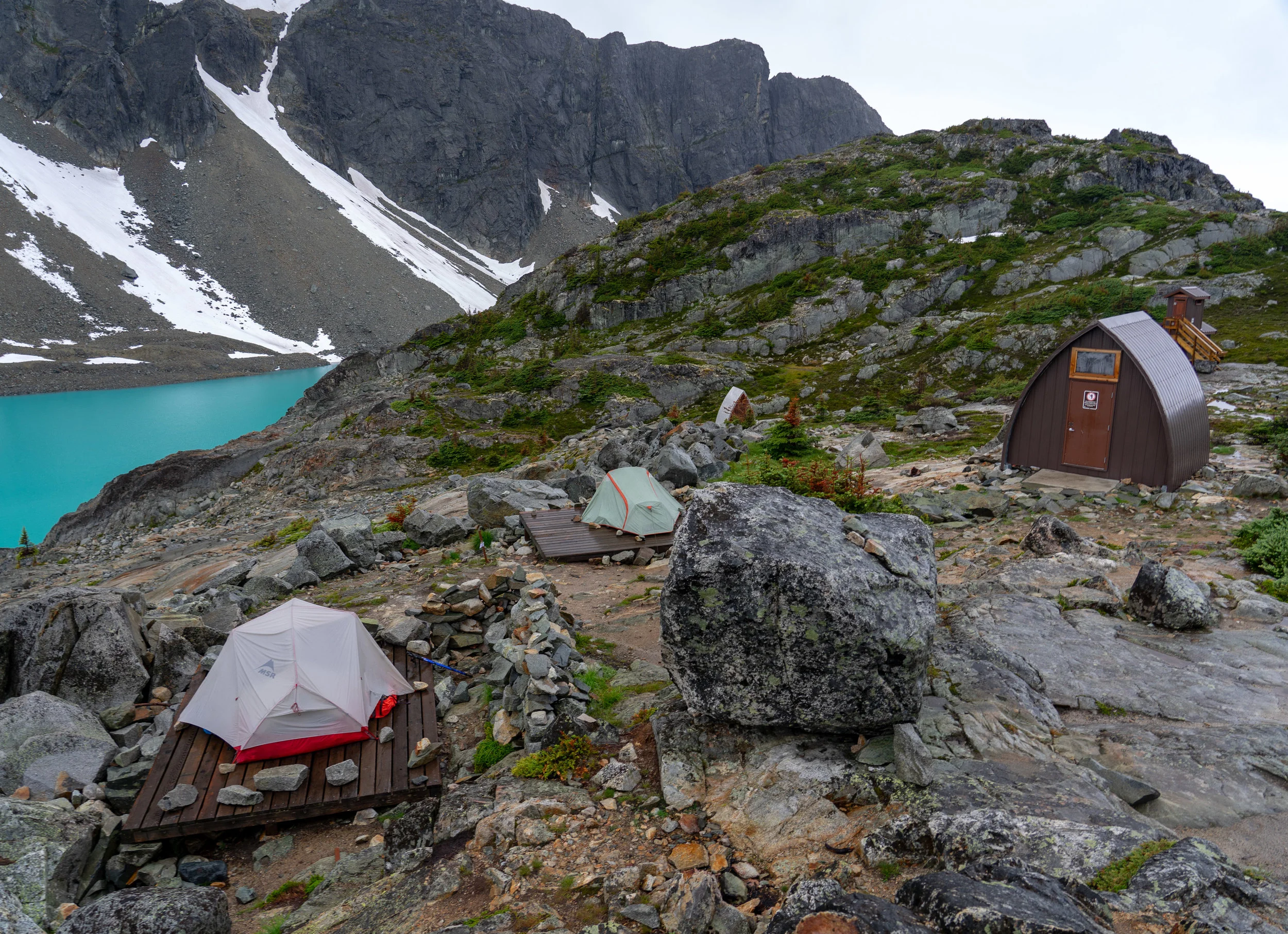The hut and two of the tent pads at Wedgemount Lake.