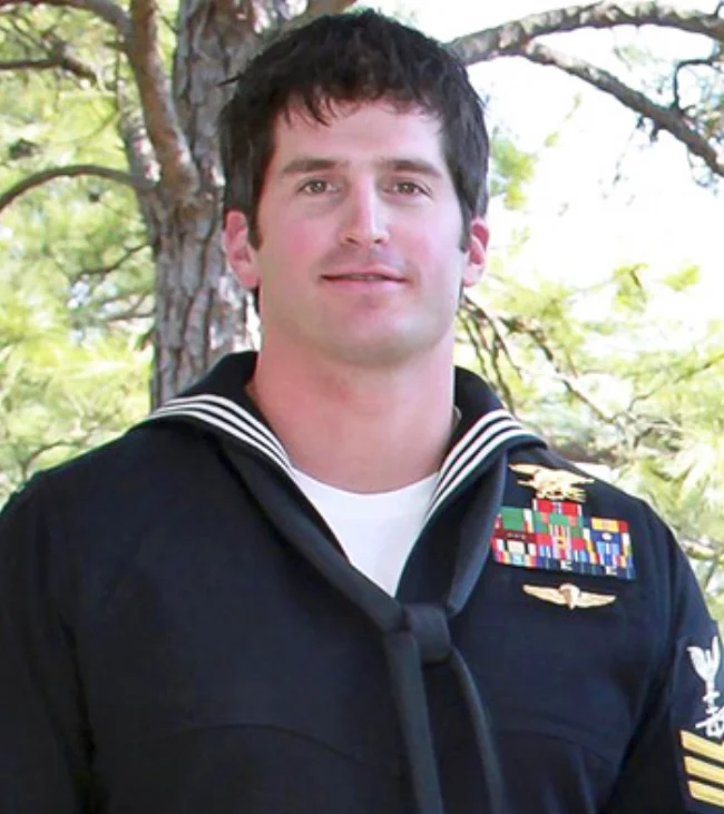 U.S. Navy Special Warfare Operator Petty Officer 1st Class (SEAL/Enlisted Surface Warfare Specialist) Jon "JT" Thomas TuMileson, 35, of Rockford, IA, assigned to an East Coast-based Naval Special Warfare unit, died on August 6, 2011, in Wardak province, Afghanistan, of wounds suffered when his helicopter crashed. He is survived by his parents George and Kathy TuMileson, Joy and Scott McMeekan, sisters Kristie and Joy, and his dog Hawkeye. The "Tumilson" Hero WOD was first posted on crossfit.com as the workout of the day for Wednesday, July 4, 2012 (120704).
