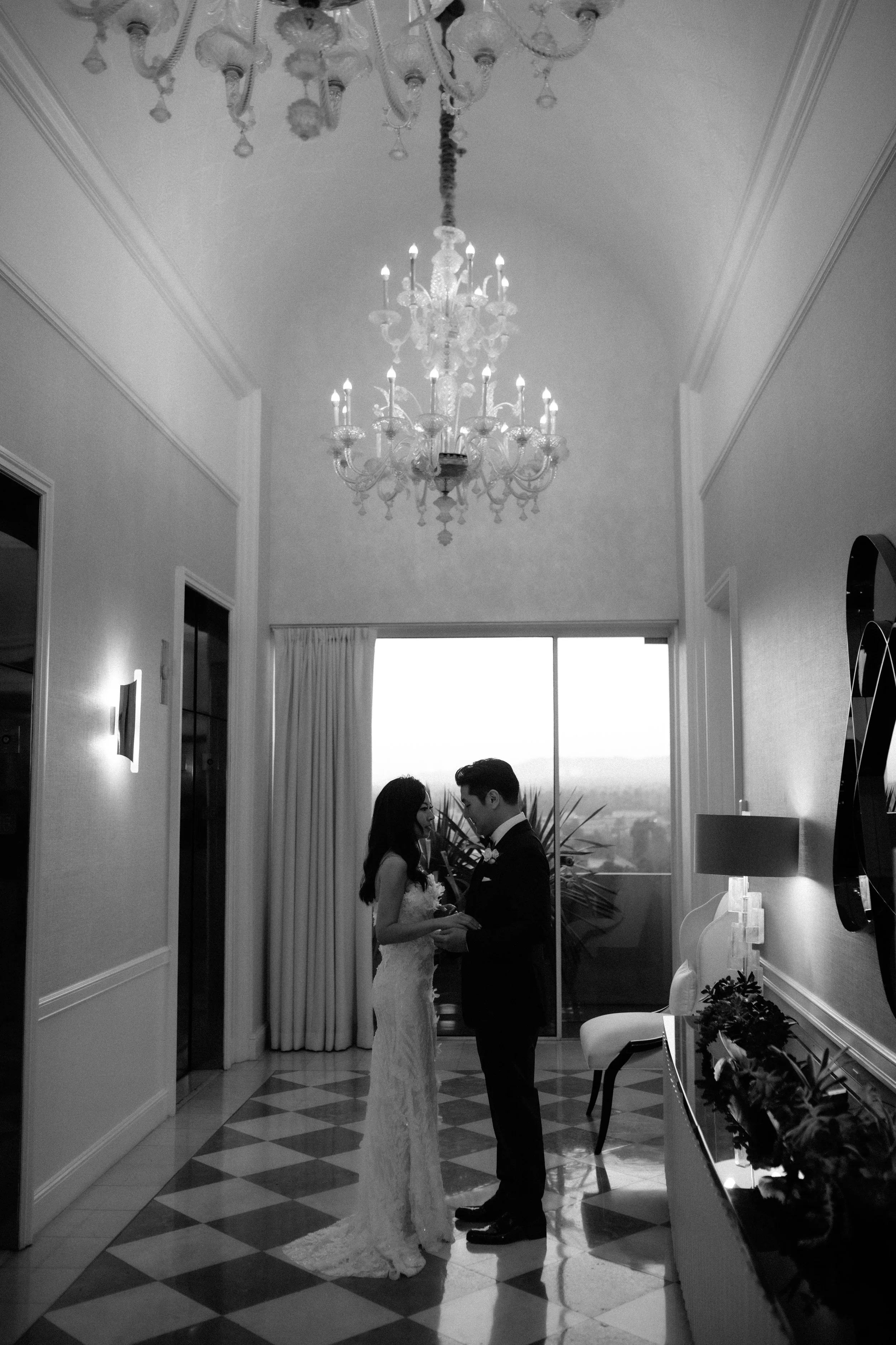 Bride and groom practice their first dance as they wait for the elevator to take the to the grand ballroom of the Four Seasons Hotel Los Angeles