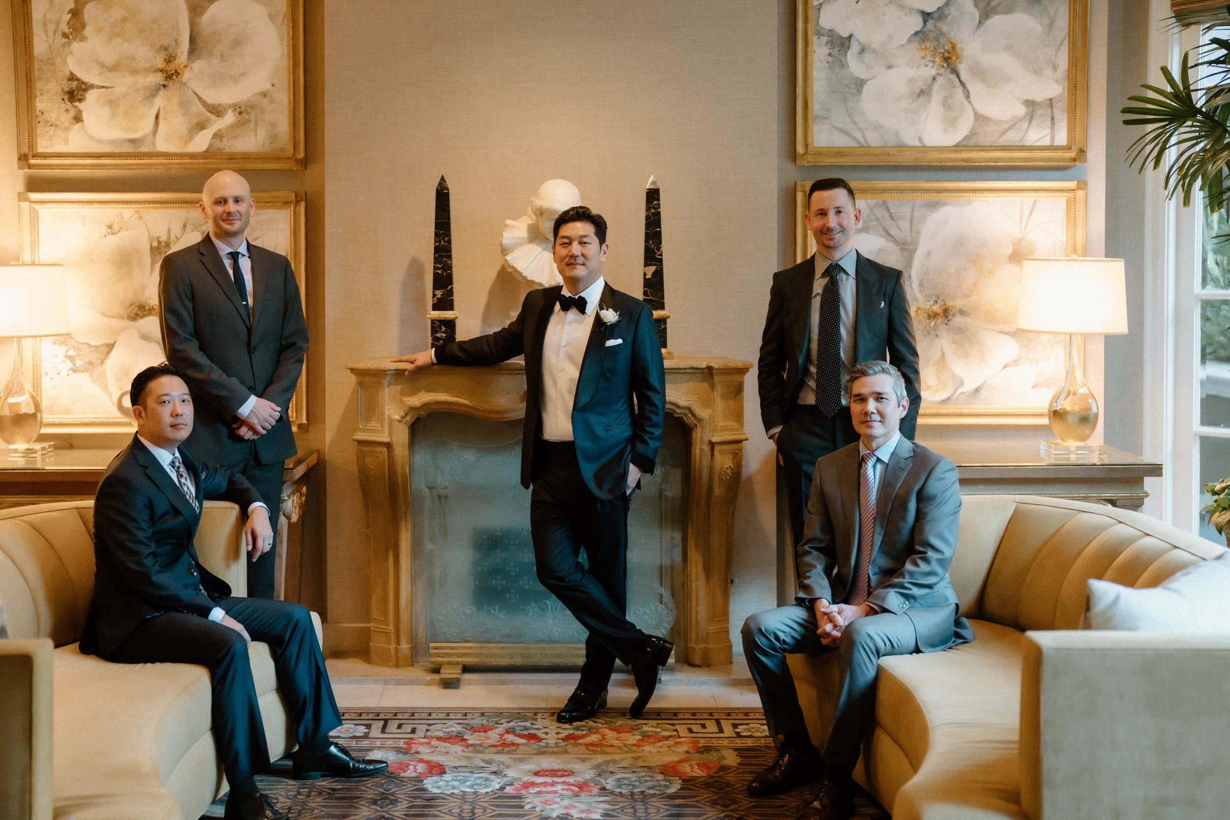 Groom surrounded by Groomsmen in lounge at Four Seasons Hotel Los Angeles at Beverly Hills before the wedding ceremony in the garden