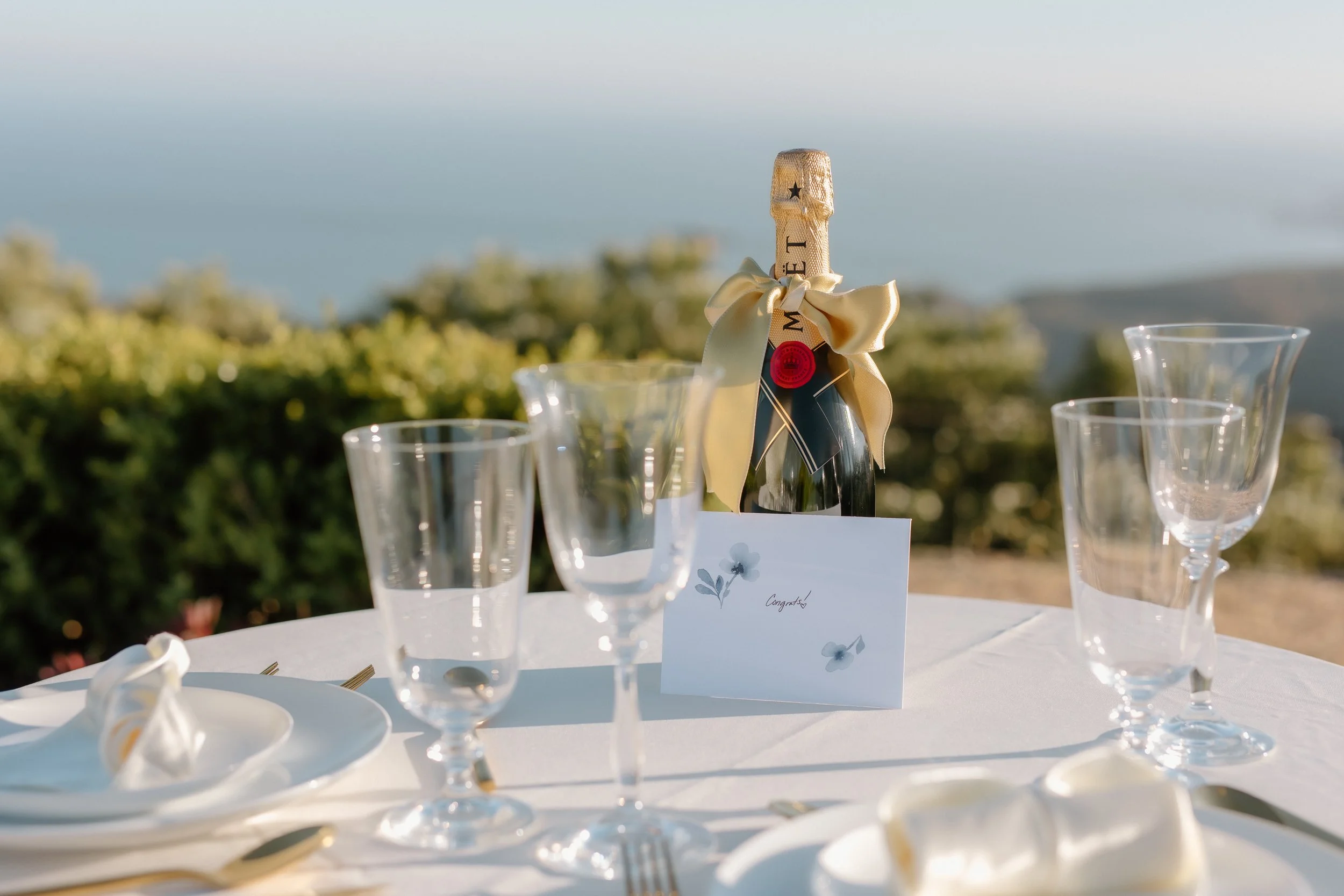 A bottle of Moet at a table for two overlooking the Pacific Ocean