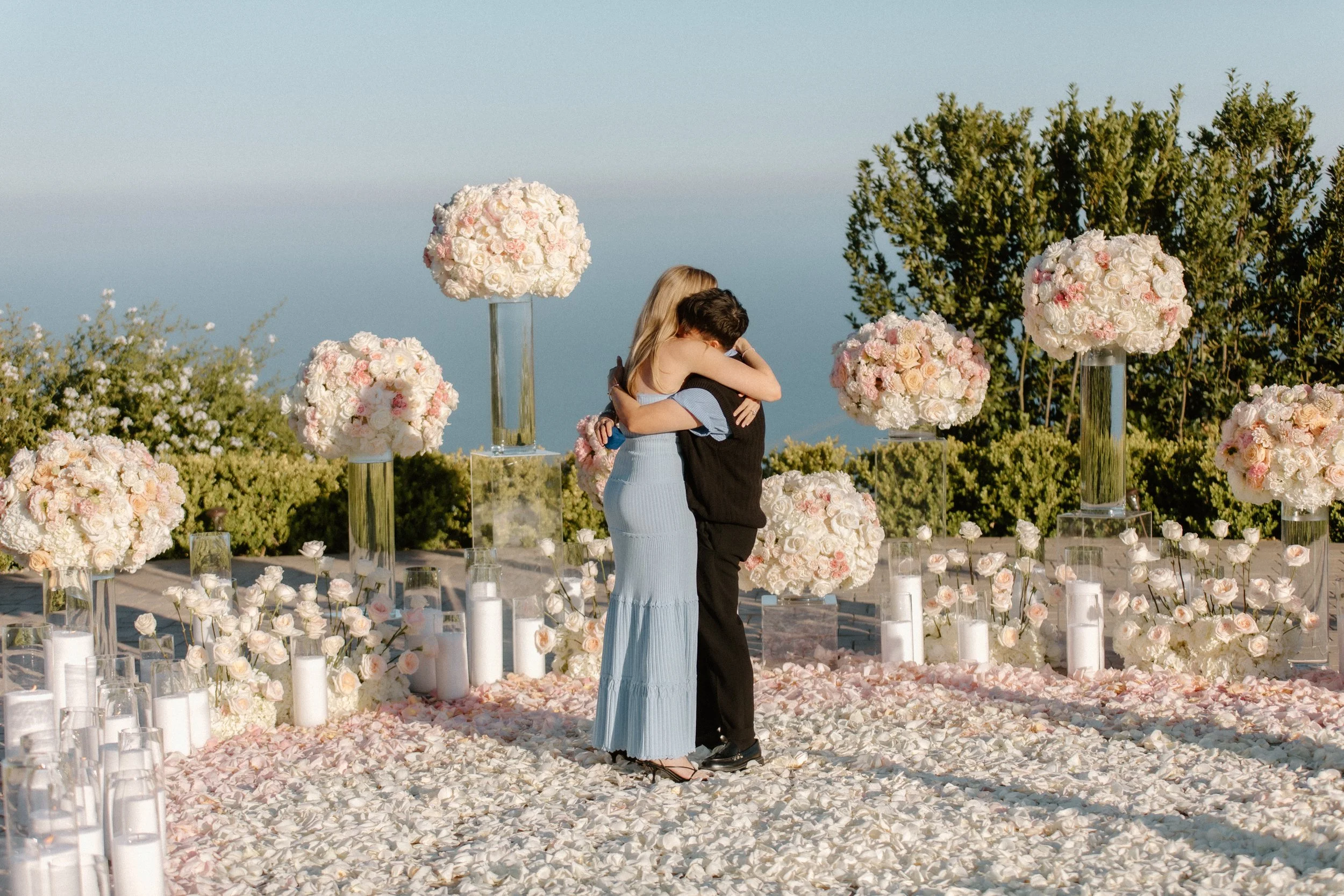 Couple embraces after surprise luxury proposal at Malibu Mansion