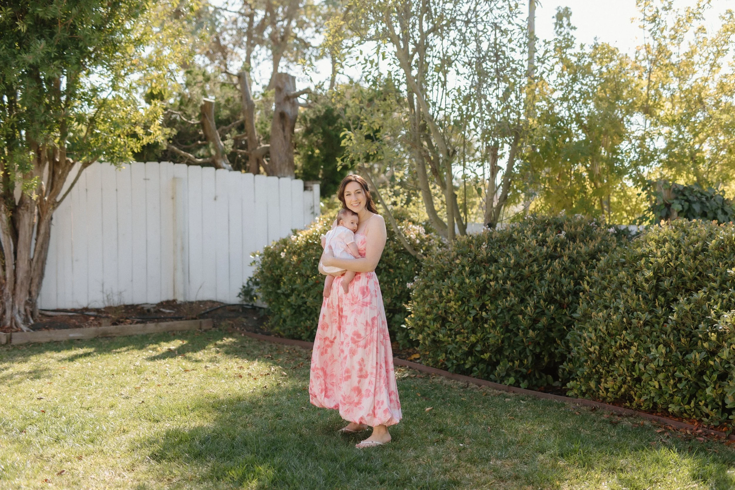Mother dancing with baby in garden