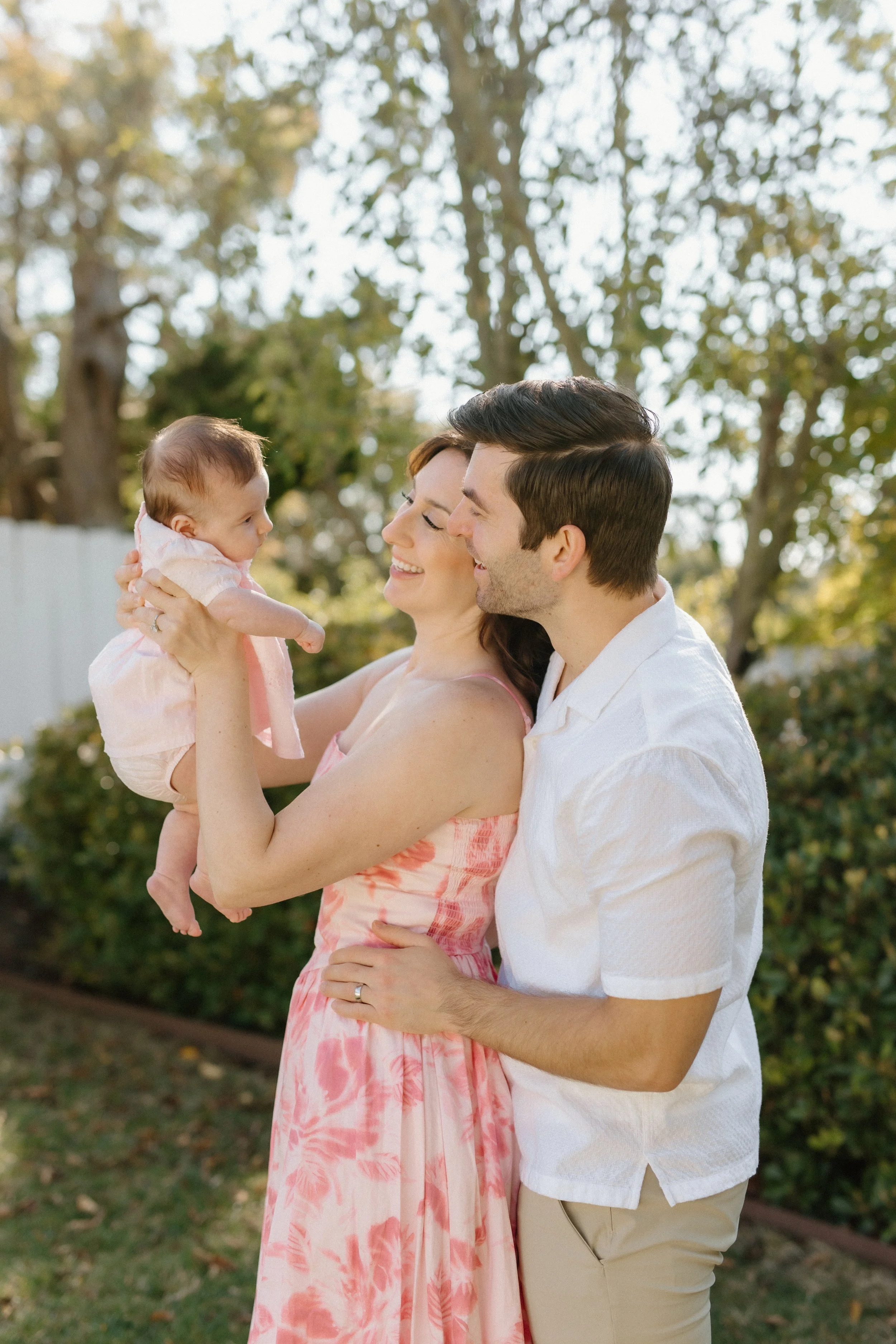 mother and father in garden with baby