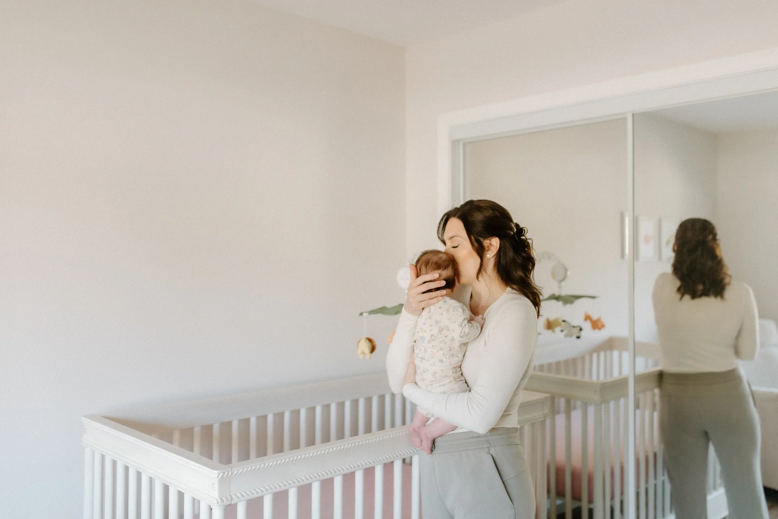 mother with baby in nursery at home