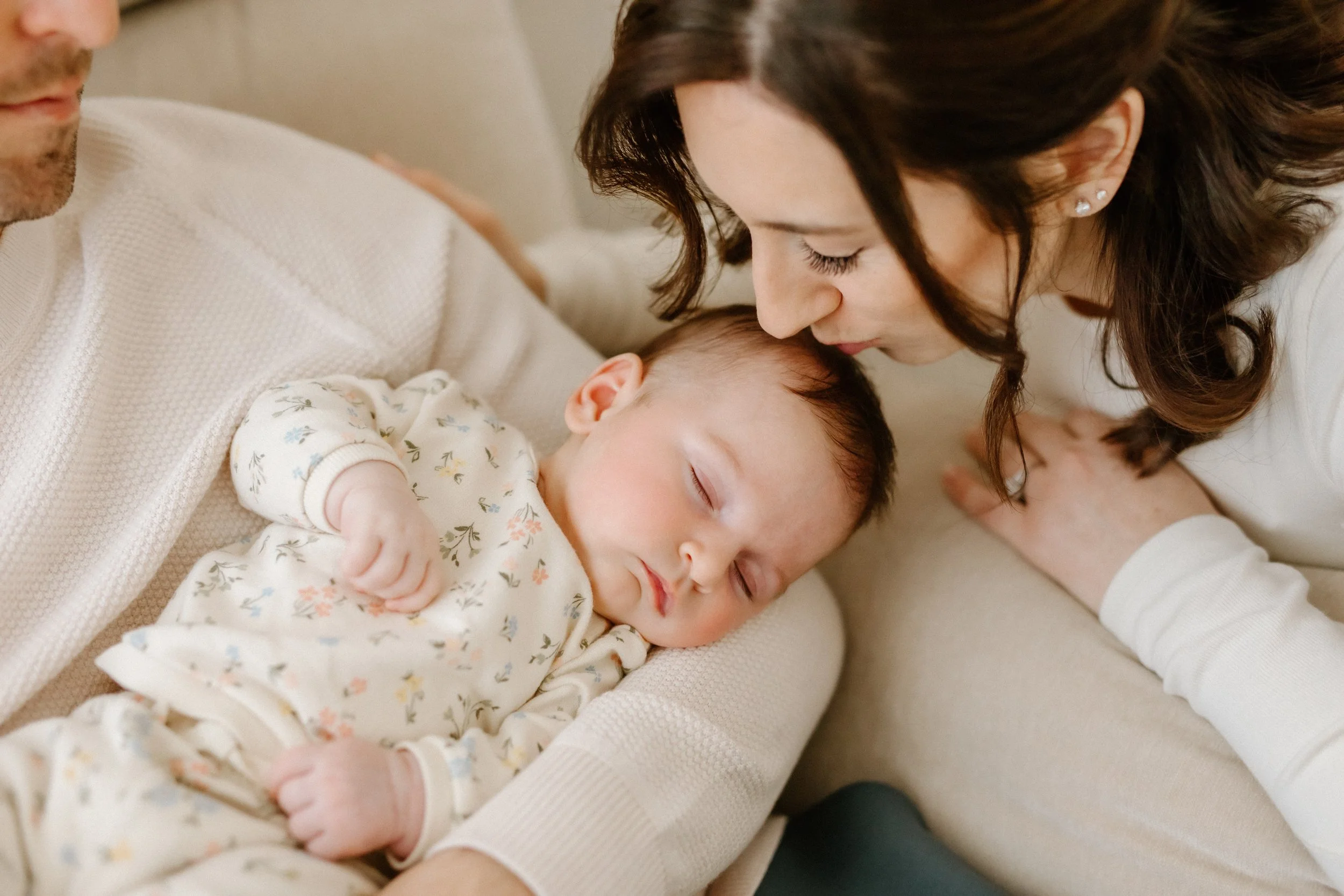 mom kissing new baby