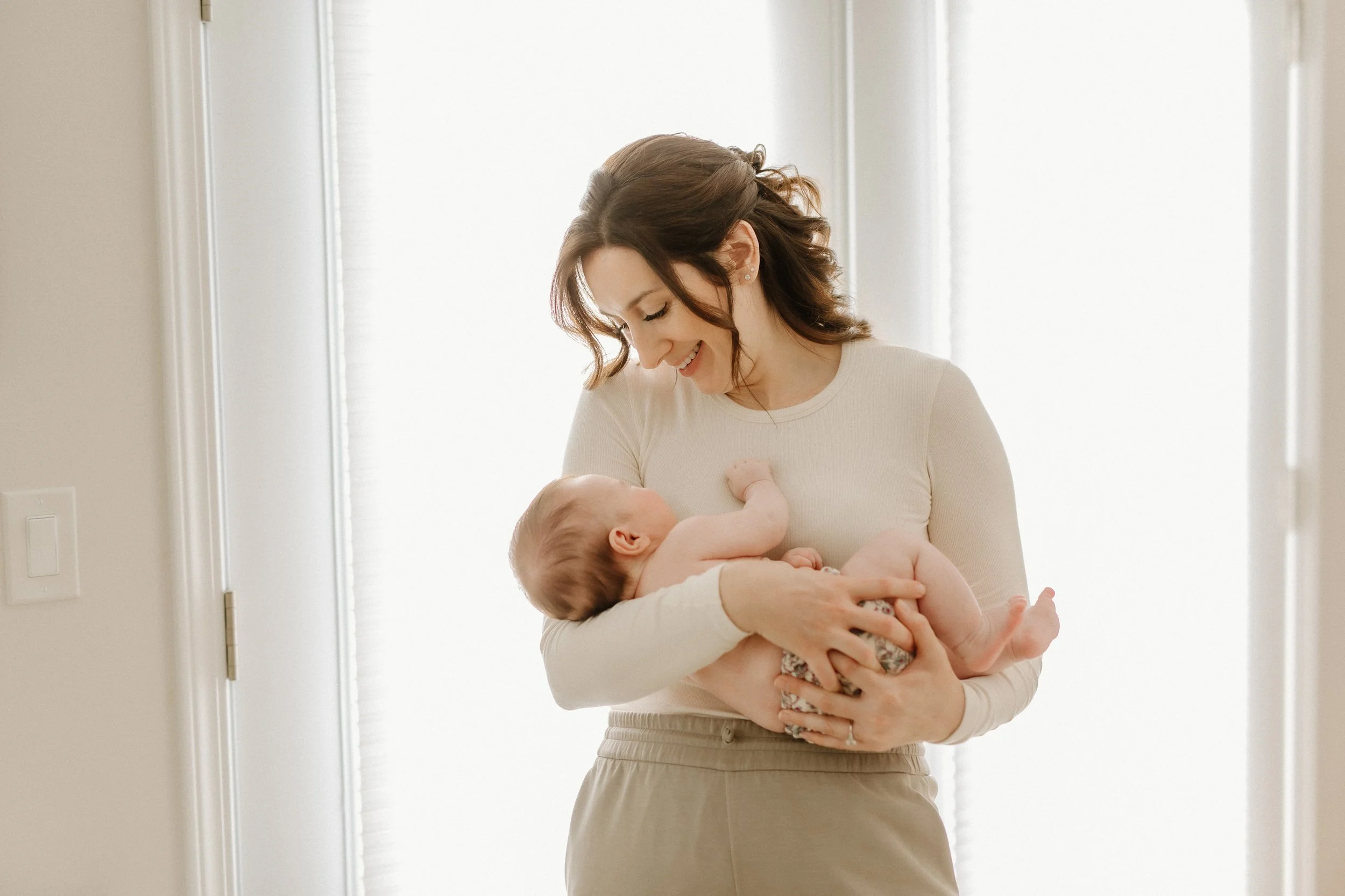 mother rocking new baby to sleep