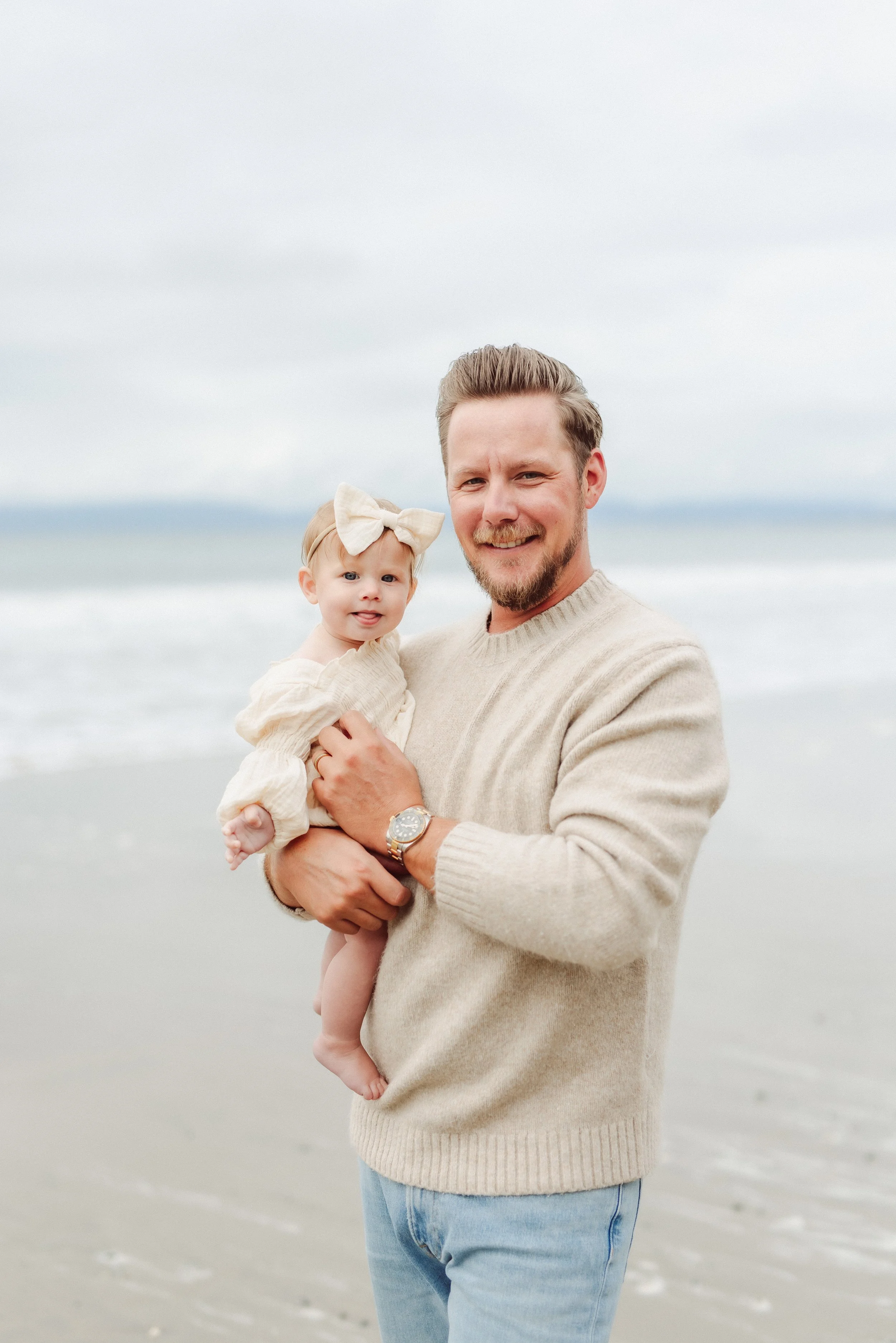 Dad with new baby on a beach in california