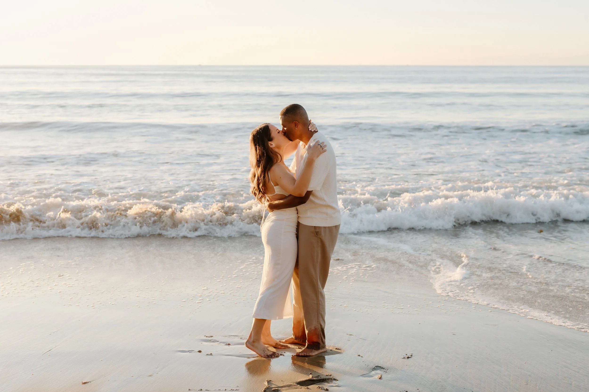 kiss on the beach during engagement session