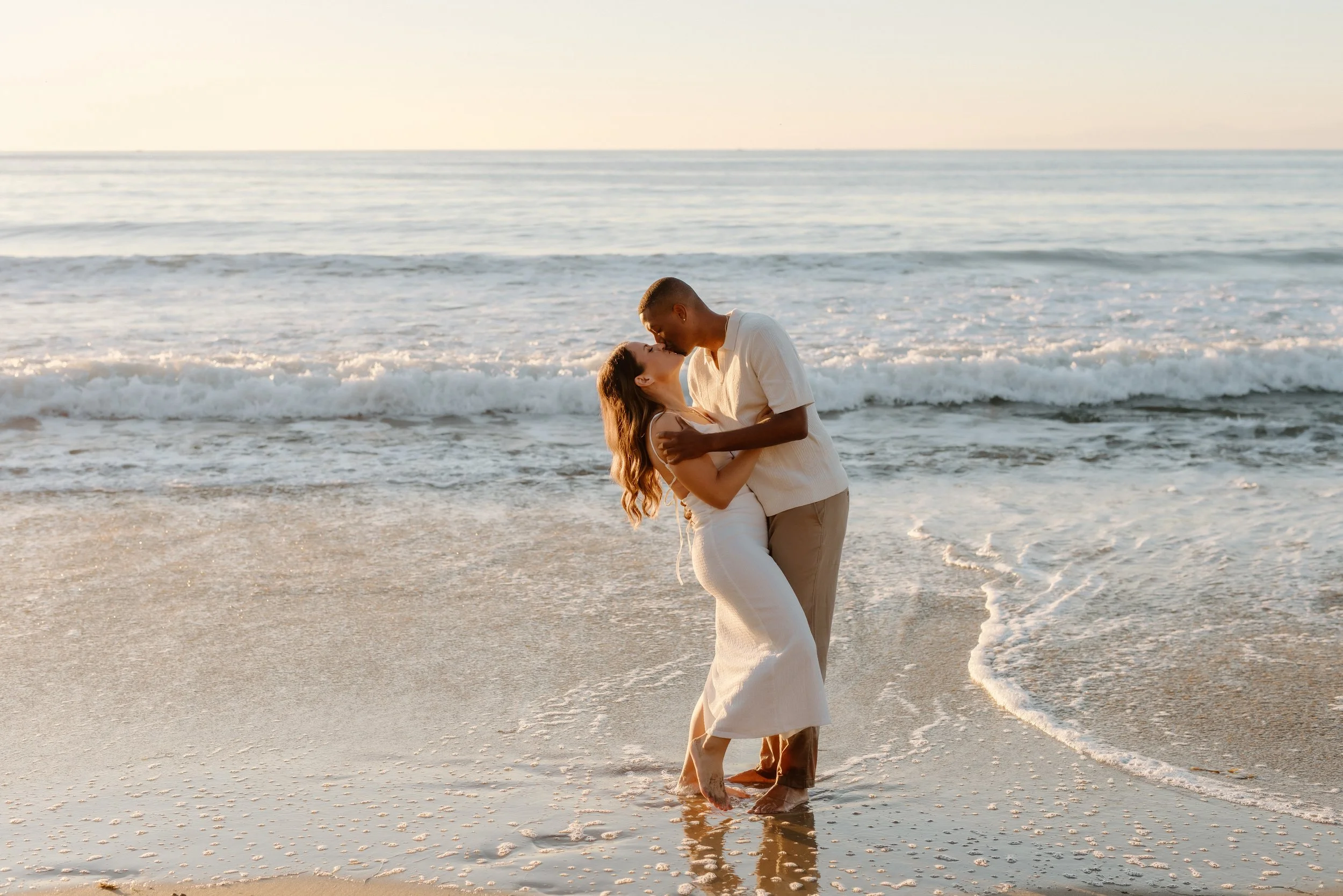 dip and kiss on the beach during engagement session