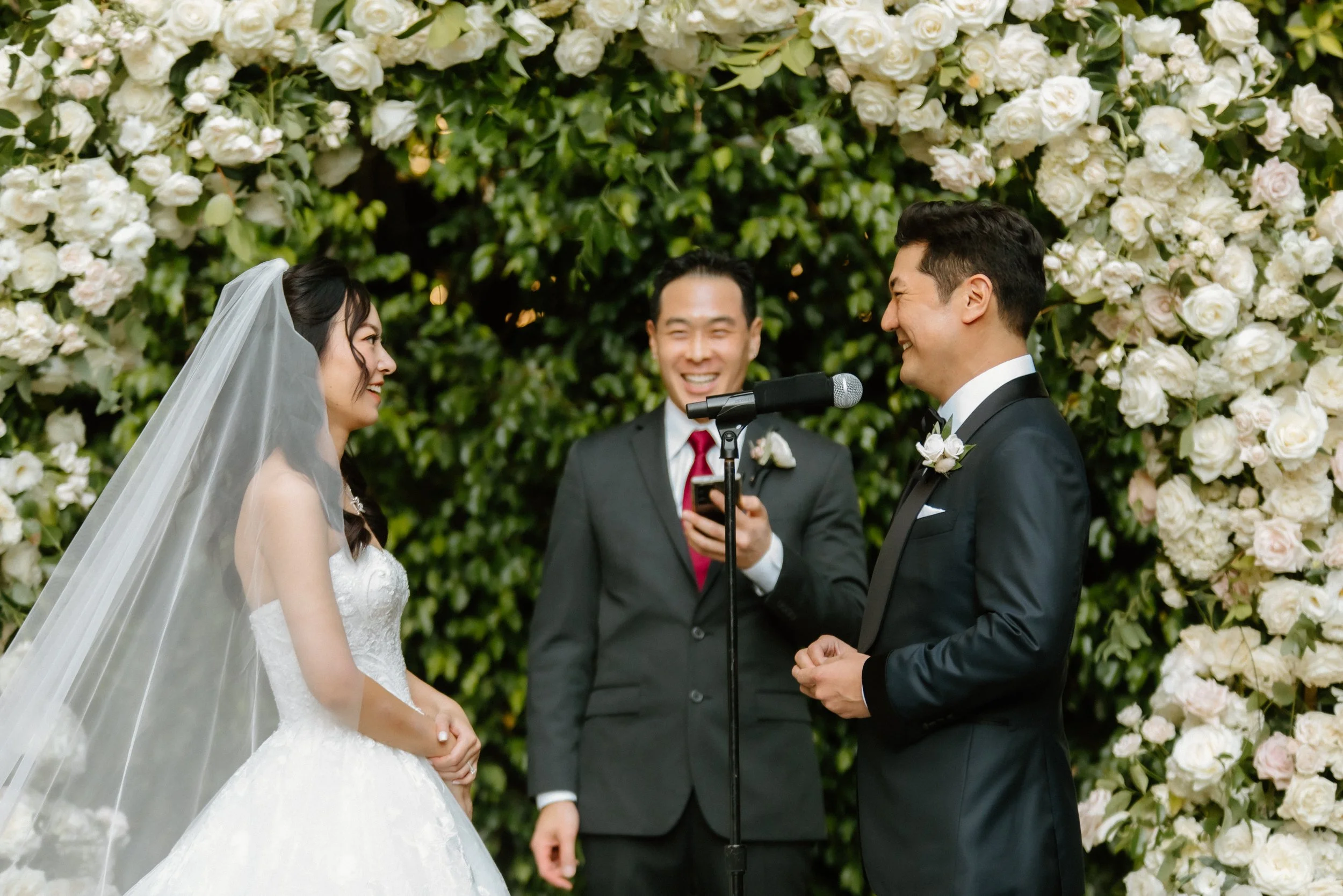 Bride and groom share laughter during their garden wedding ceremony at Four Seasons Hotel