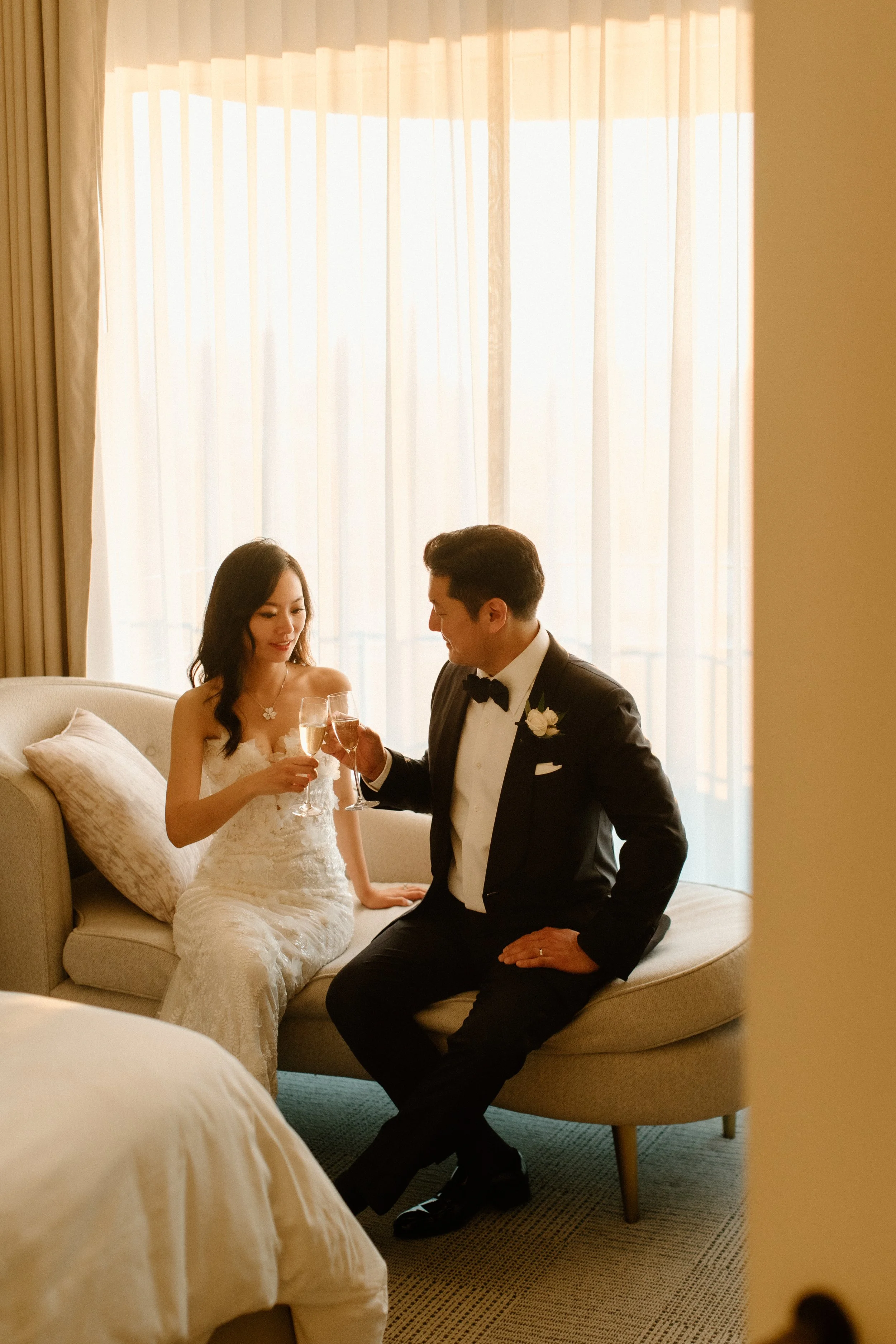 Bride and groom toast to the future in the wedding suite before they go down the their reception and greet their guests in the Grand Ballroom of the Four Seasons Hotel Los Angeles
