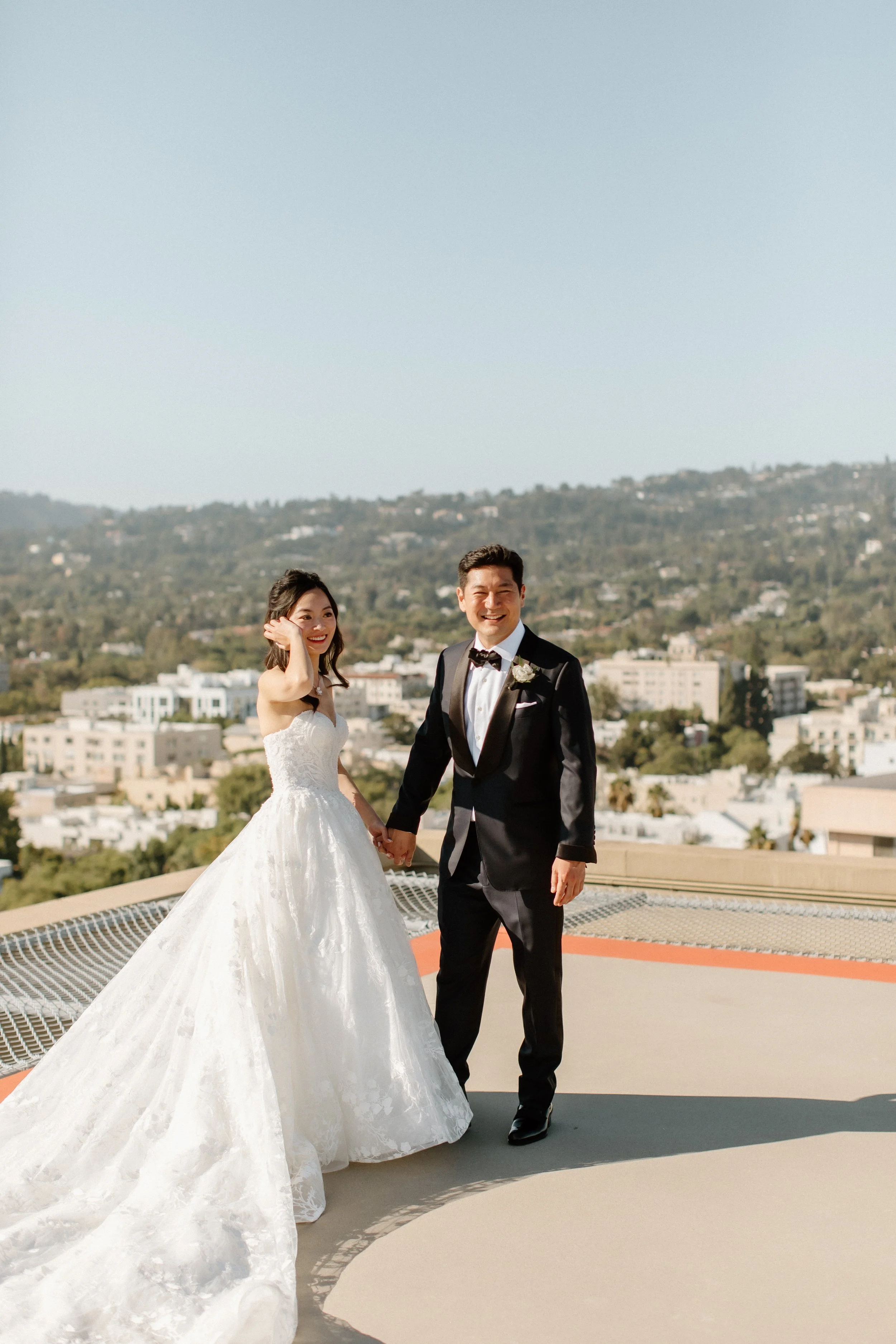 Bride and groom on Helipad with hills of Los Angeles in the background