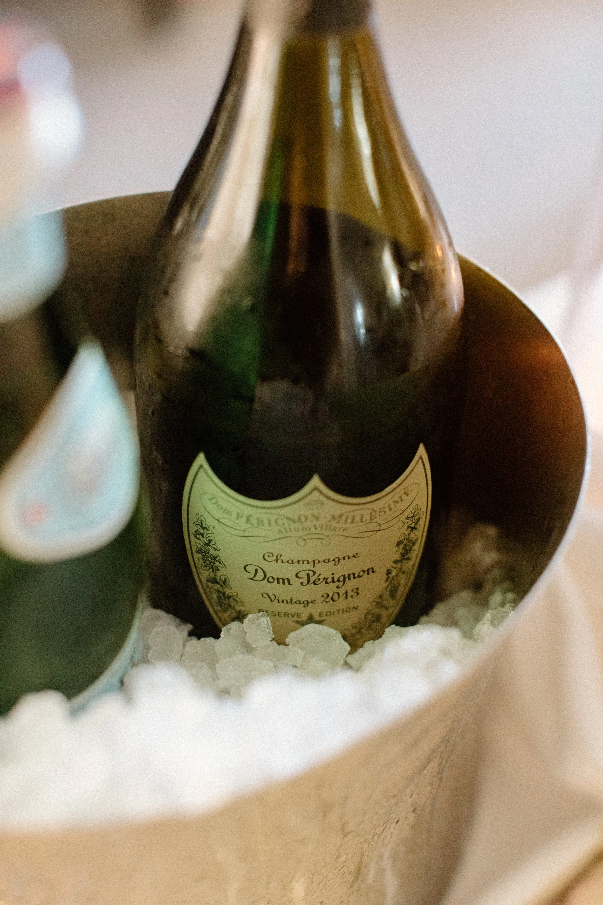A bottle of Dom Perignon chills in the wedding suite as the bride and groom change attire and transition to the wedding reception in the grand ballroom at Four Seasons Hotel