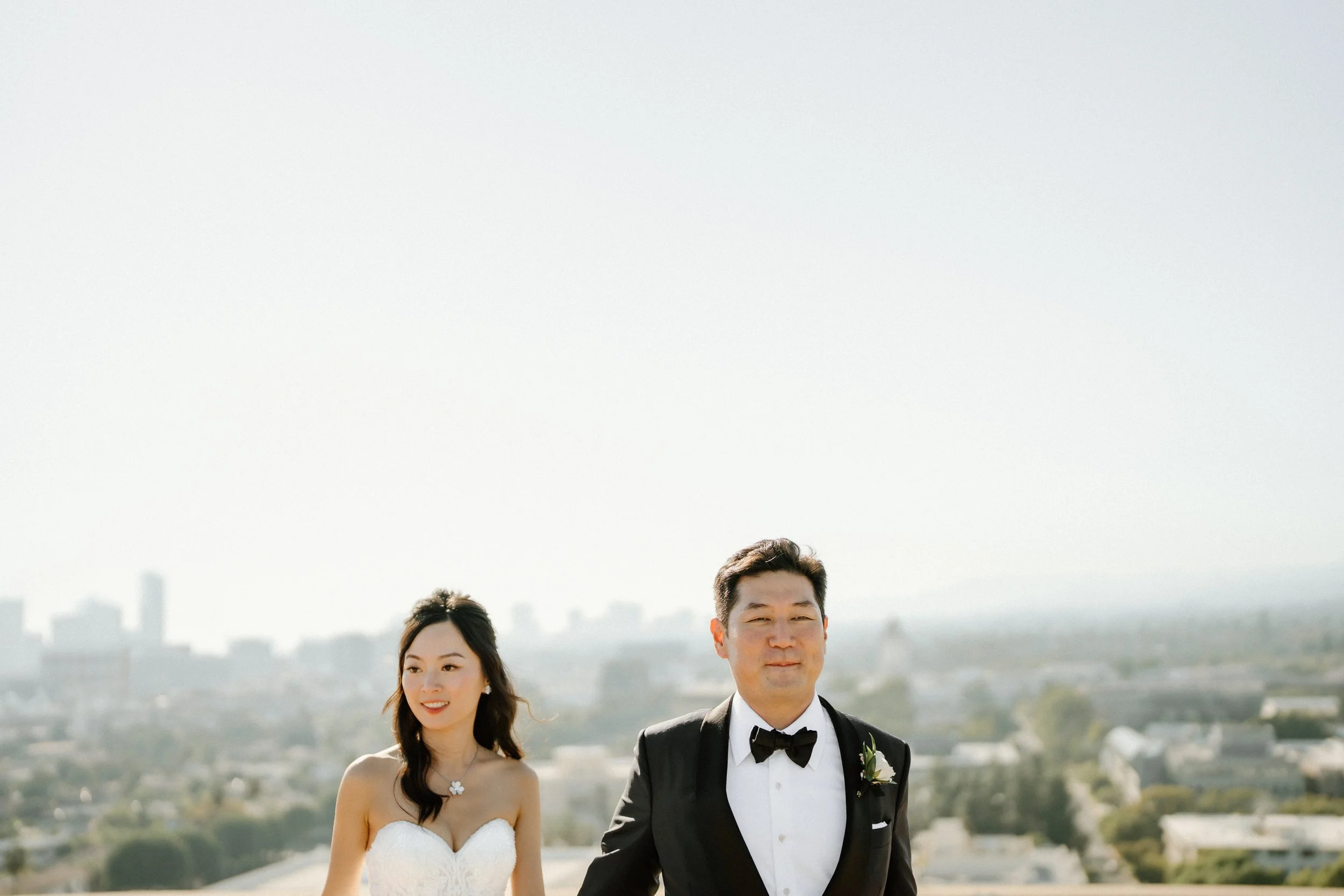 Bride and groom portrait with Los Angeles city skyline in the background