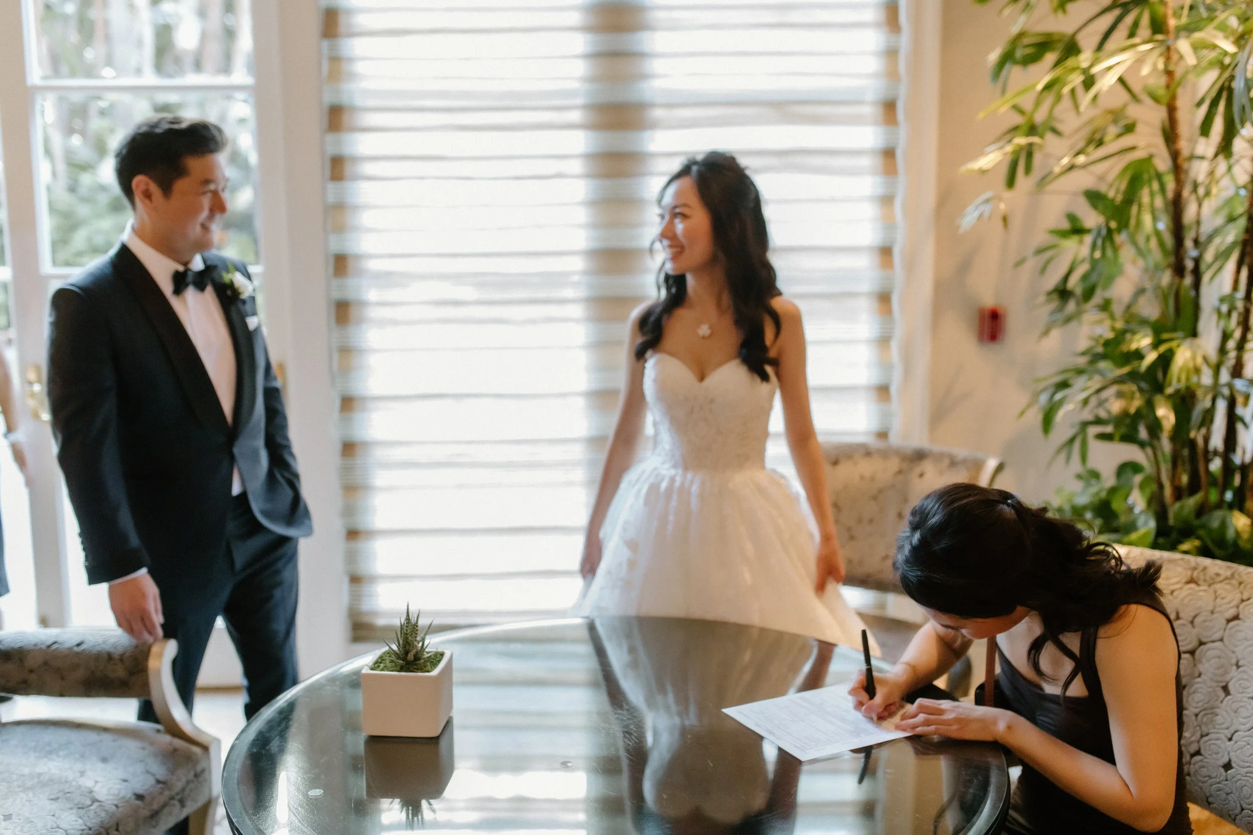 Maid of honor signs marriage license in the lounge at Four Seasons Hotel