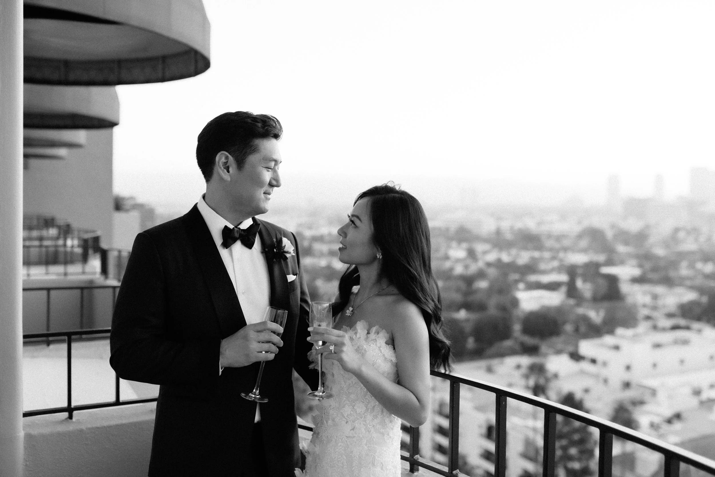 Black and white photo of bride and groom on their balcony at Four Seasons Hotel Los Angeles