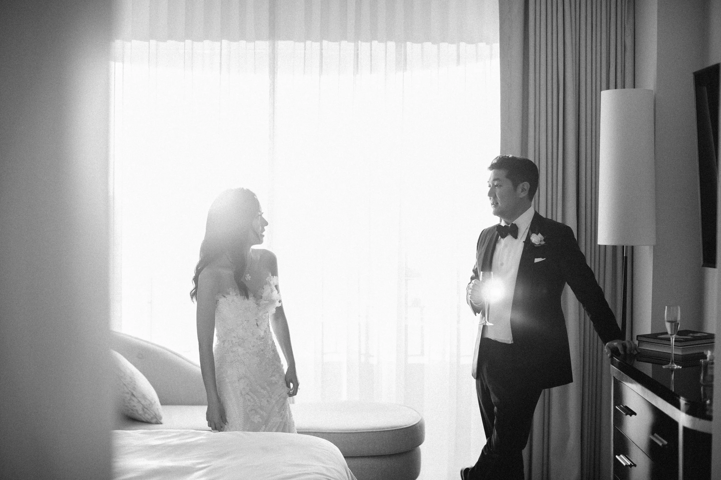 Bride and groom chat in their wedding suite of Four Seasons Hotel in Los Angeles before the meet their guests in the grand ballrom