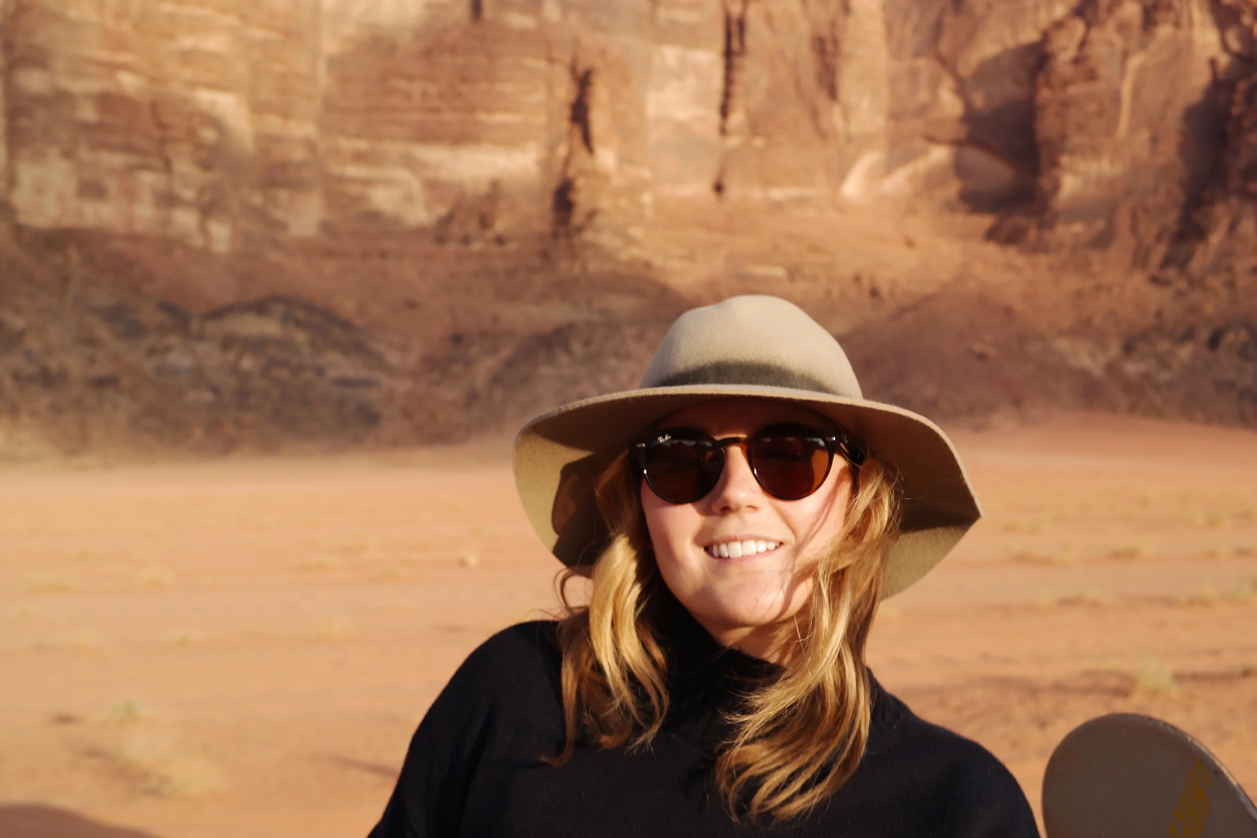 Here I am in my favorite hat riding around in the back of a truck in Wadi Rum, Jordan. Fun Fact: The Martian with Matt Damon was filmed in Wadi Rum.