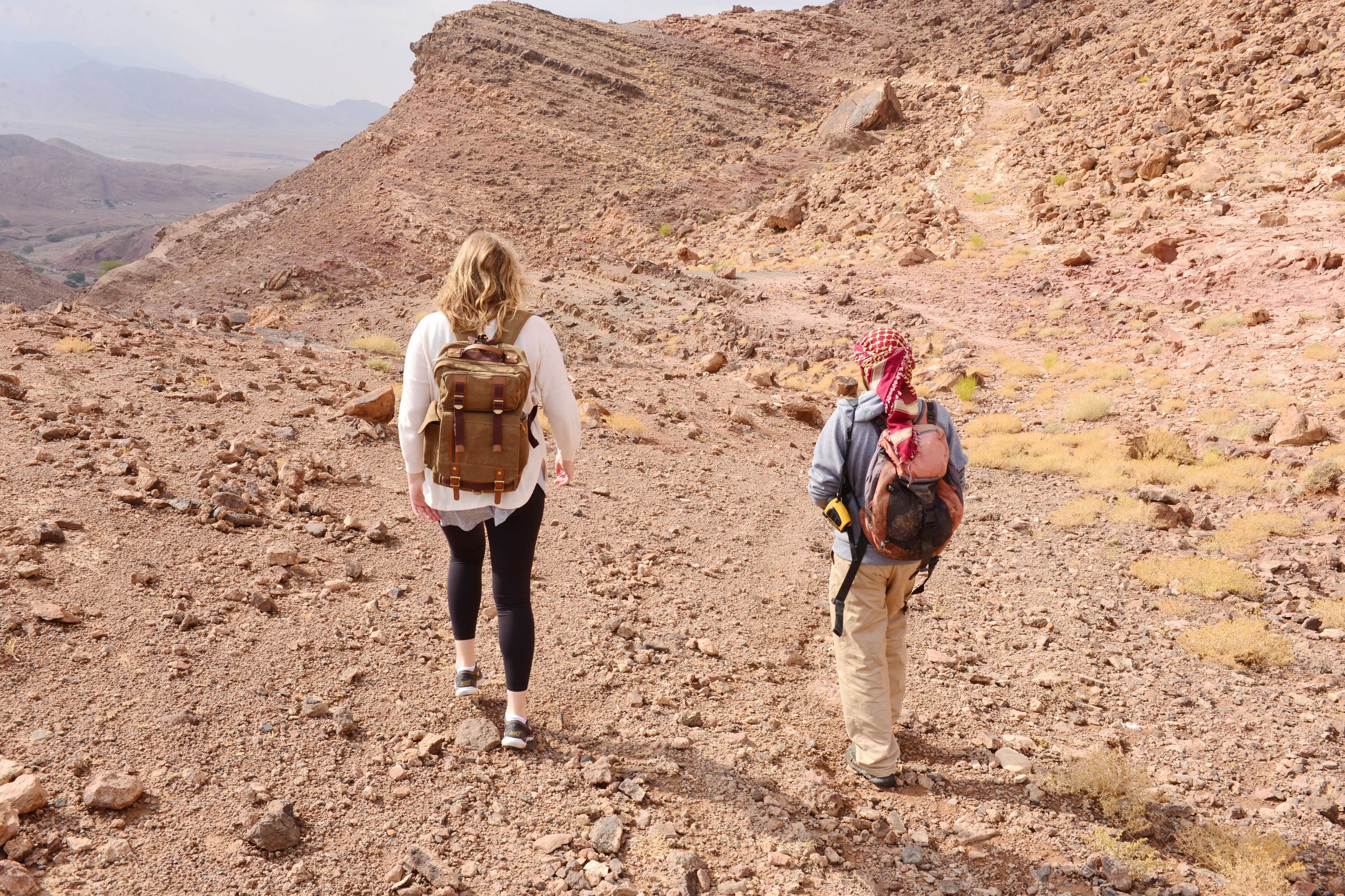 Charlotte & our Bedouin guide hiking along the ancient copper mine trail in the Dana Biosphere Nature Reserve.