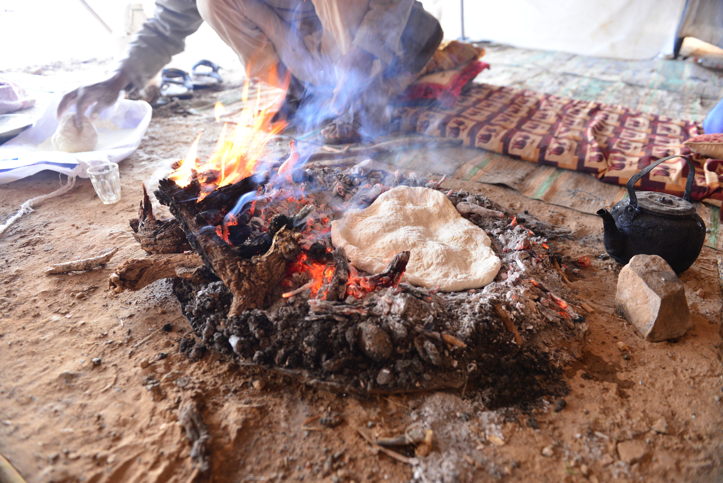 Bedouin making bread during a local community visit.
