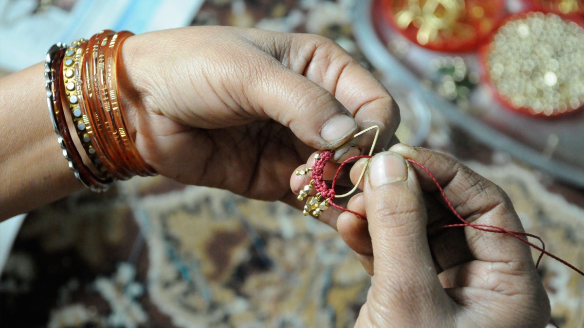 Artisan making earrings for The Didi Jewelry Project in India