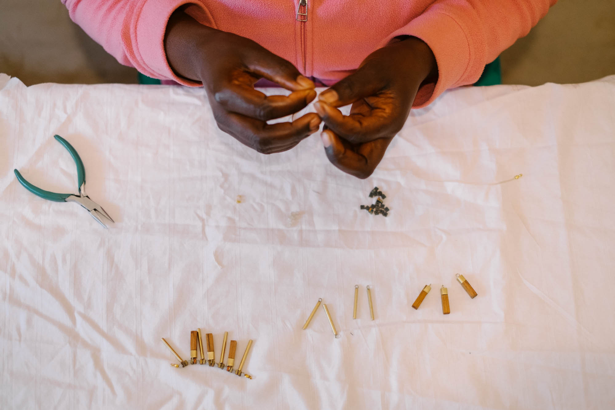 Artisan making jewelry for Jimani Collections in Kenya