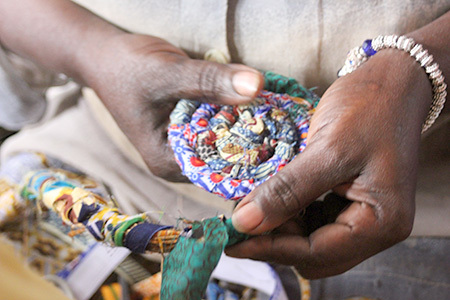 Artisan hand weaving a product for Grain of Rice Project in Kenya