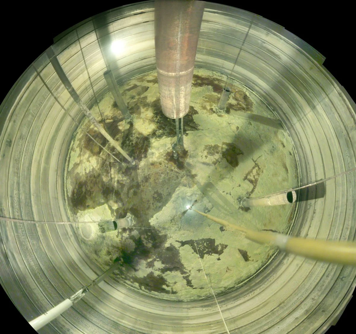  Solid radioactive and chemical waste inside Tank A-102 at the Hanford Site before workers started breaking it up to remove waste. 