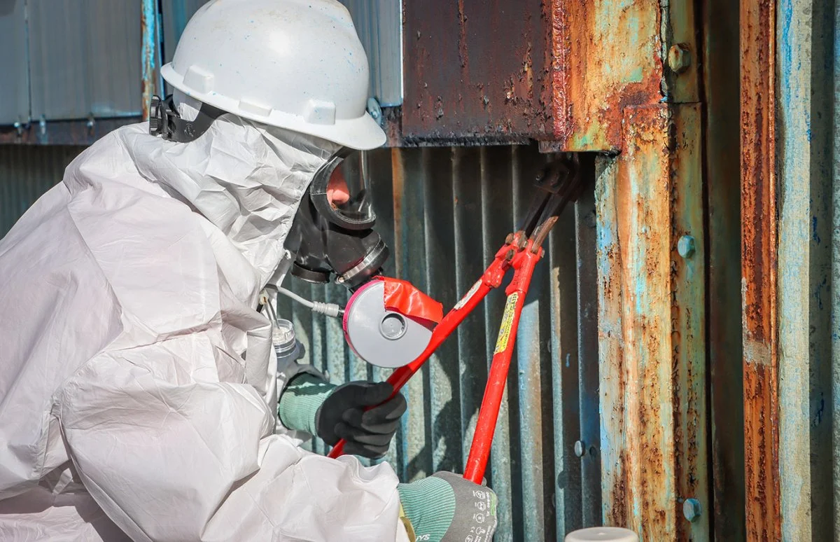  Asbestos Worker Luke Fryman cuts the first bolt of the X-333 Process Building at the Portsmouth Site to kick off demolition activities. 