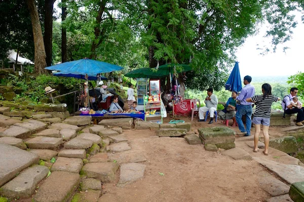 The ubiquitous refreshments and souvenir stall at the top of the stairs is a welcome sight (cold water!) at the top of the 1,000 year old Wat Phu, in Champasak, Laos. It was part of the Khmer empire, akin to Angkor Wat in Cambodia | Eat Drink Laos http://eatdrinklaos.com/blog/southern-laos-wat-phu
