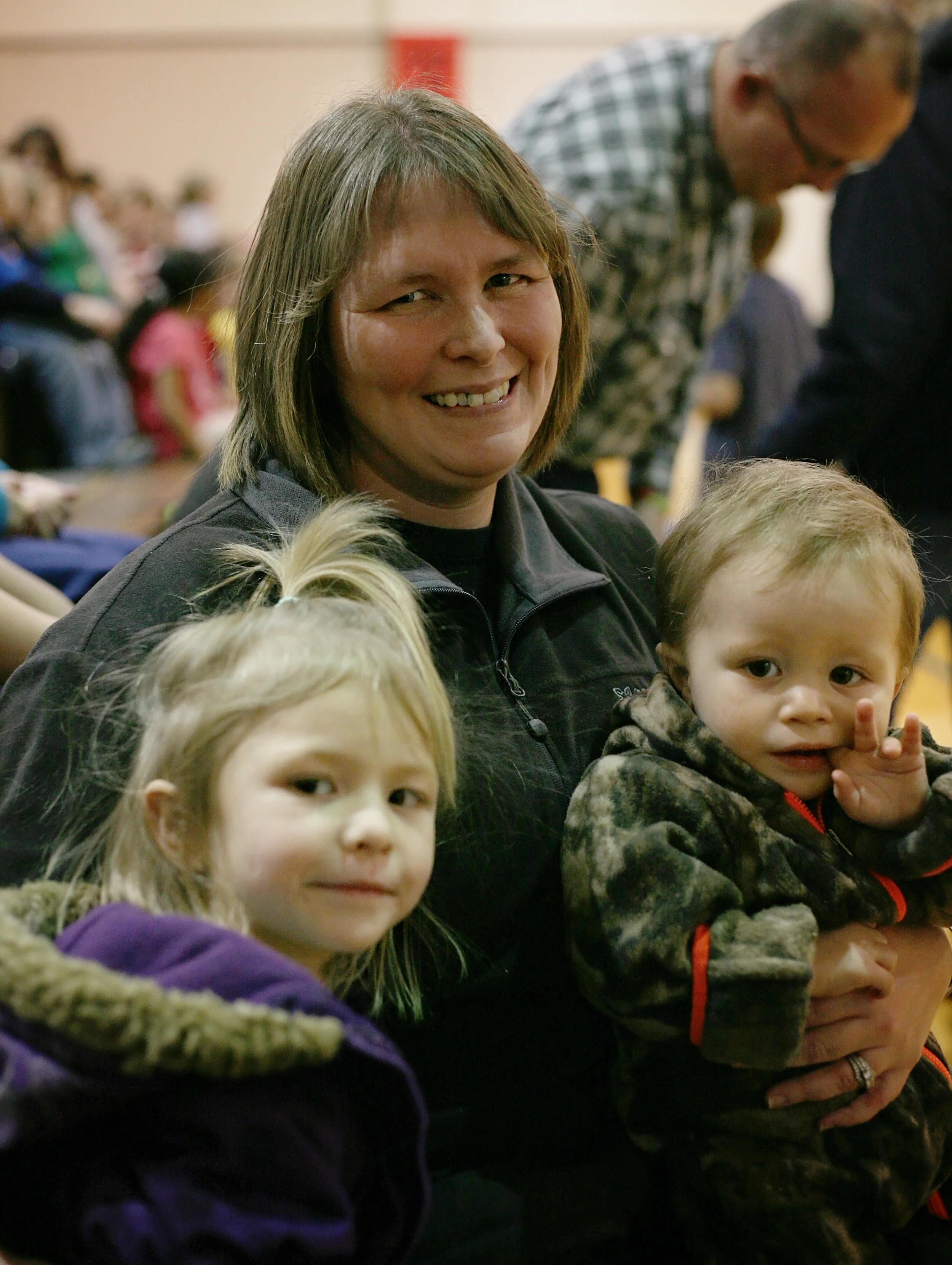 A woman and 2 children enjoy the event