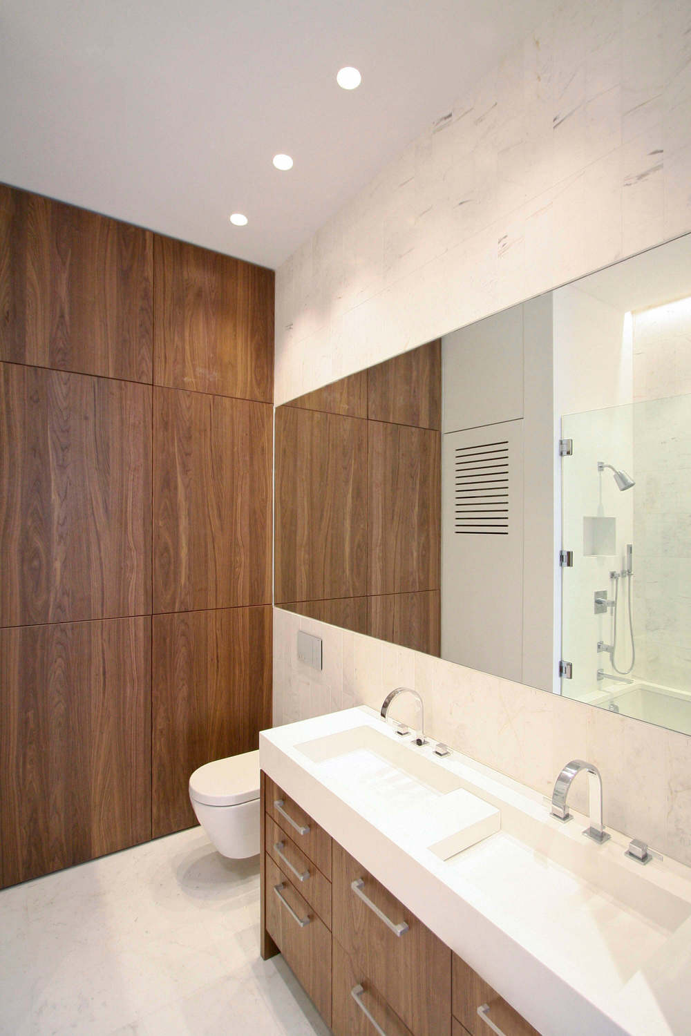   Guest Bathroom  &nbsp;- Walnut vanity with custom-designed Corian sinks;&nbsp;built-in Walnut storage unit; marble tile; and integrated Corian laundry closet.  